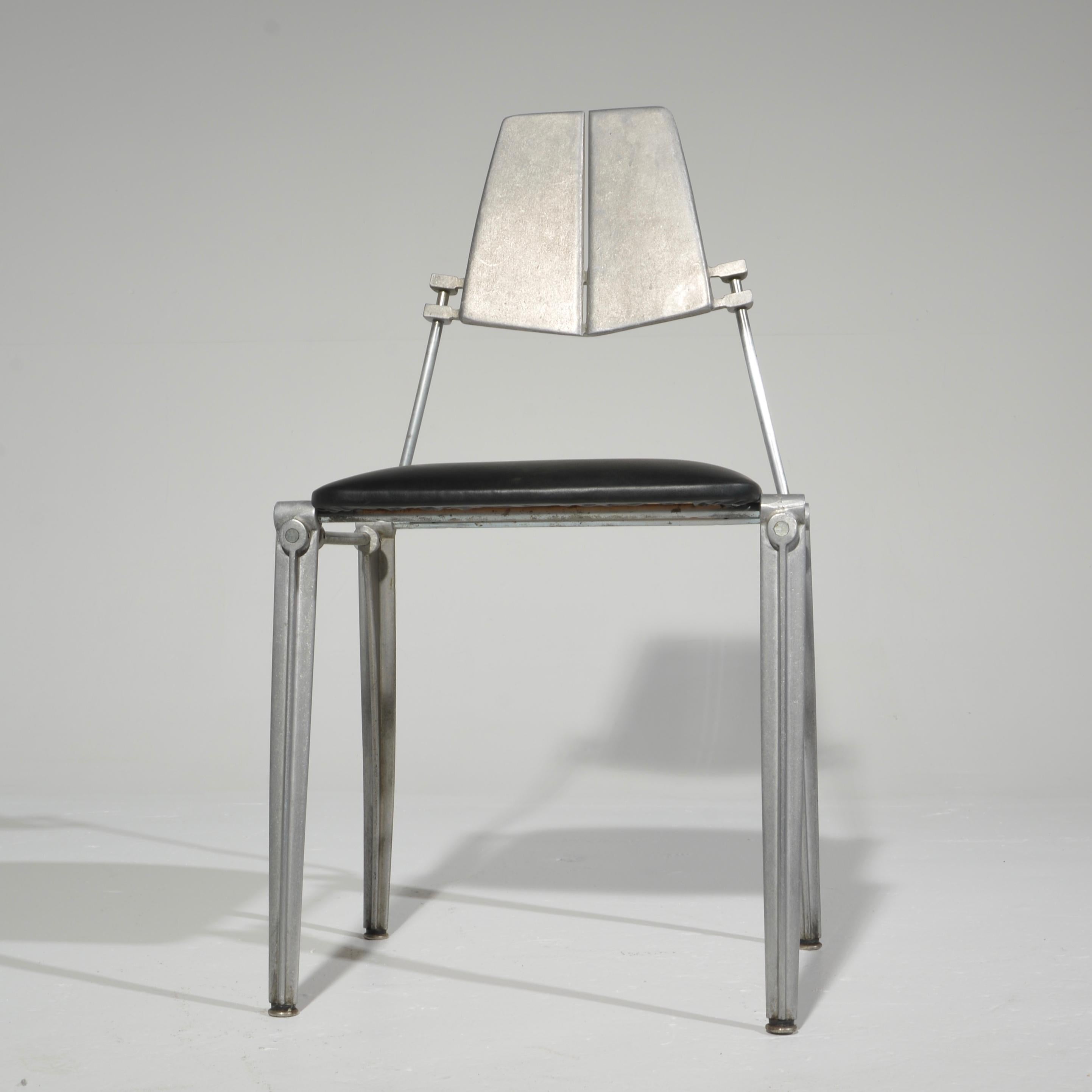 Robert Josten cast aluminum dining chair upholstered in black vinyl. 