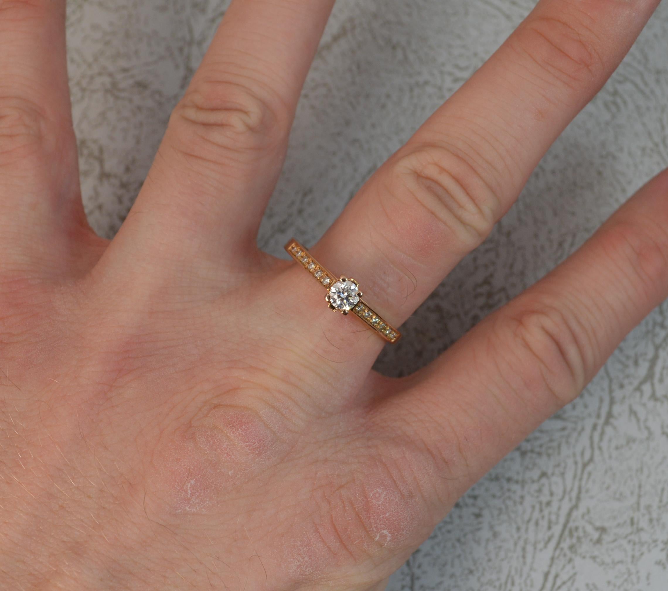 A superb 18ct Rose Gold and Diamond engagement ring.
Designed with a round brilliant cut diamond to centre in four claw setting, 0.28 carat approx. Vvs clarity, e-f colour. A very clean and sparkly diamond.
Set with a further six natural diamonds to