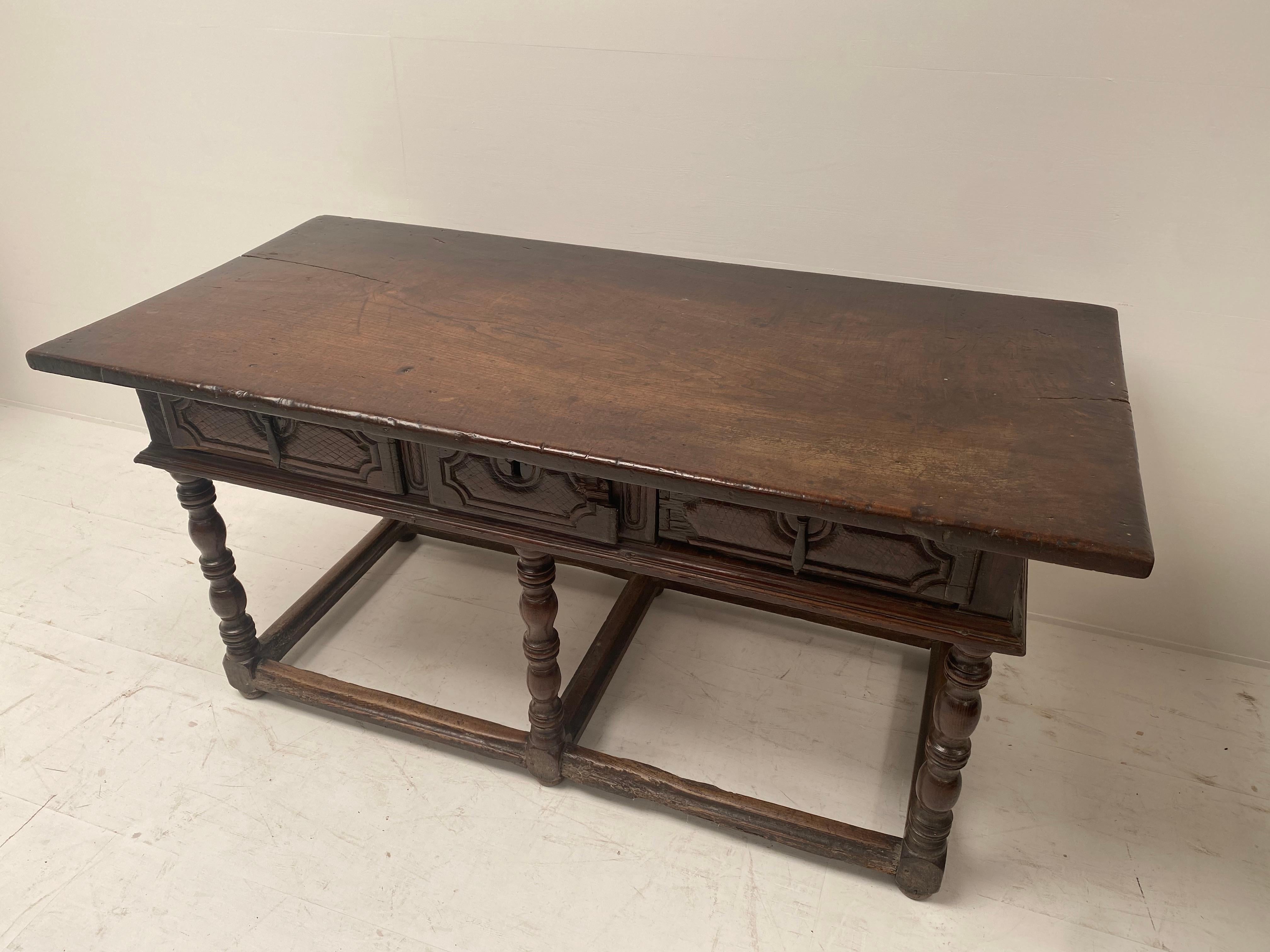Beautiful Spanish Chestnut table with 3 drawers,
one piece wood table top,
6 turned legs and simply carved panels at the back and the side of the table,
so the table can be used as a center table.
a piece of furniture with a lot of character,
looks