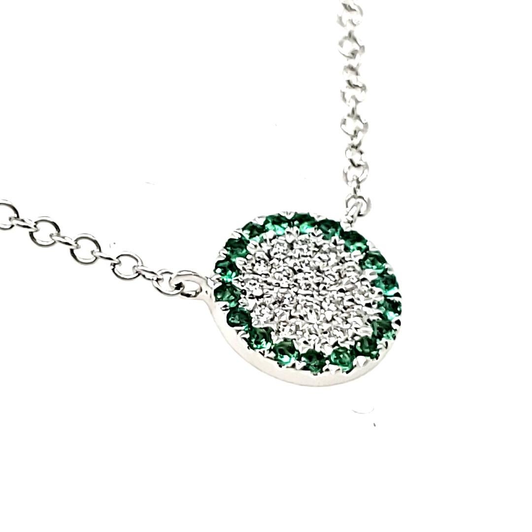 Treat yourself or someone special to the luxury they deserve.

Adorned with a stunning array of 18 emeralds from Zambia, each weighing 0.07 carats, surrounding 19 round diamonds totaling 0.06 carats set together in the center.

Crafted with care in