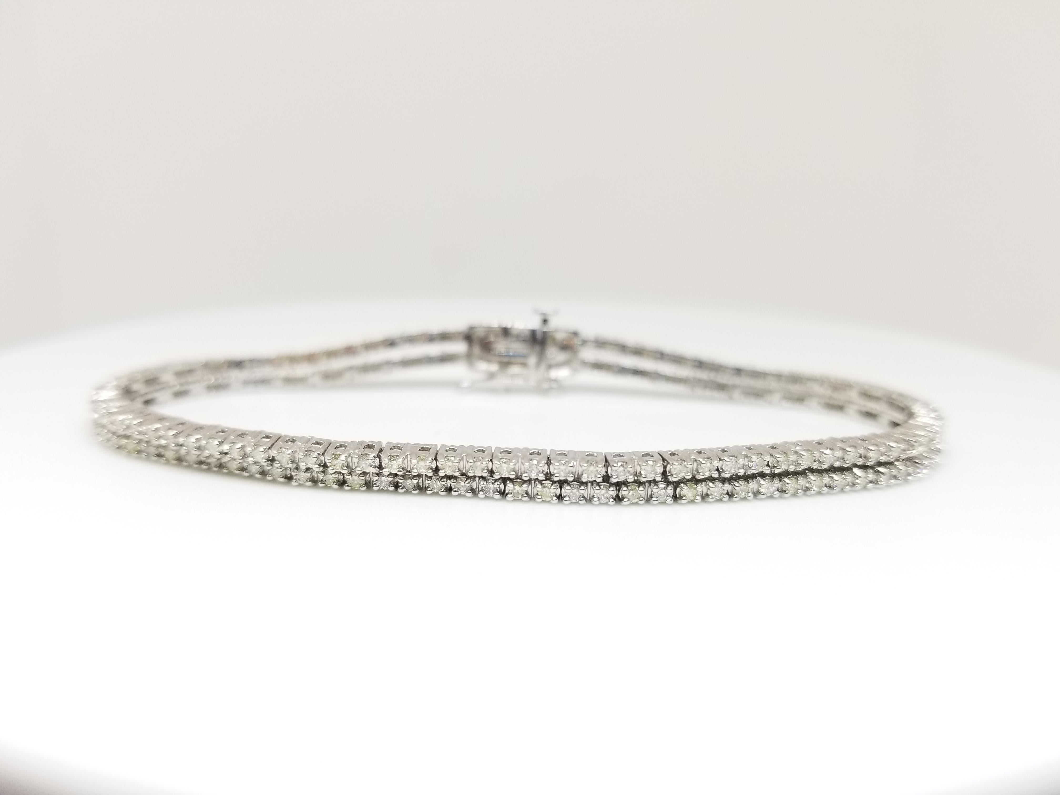 Stunning looking double row tennis bracelet, round-brilliant cut diamonds. set on 14k white gold. each stone is set in a classic four-prong style for maximum light brilliance. Average Display Color I, SI, 7 inch Length