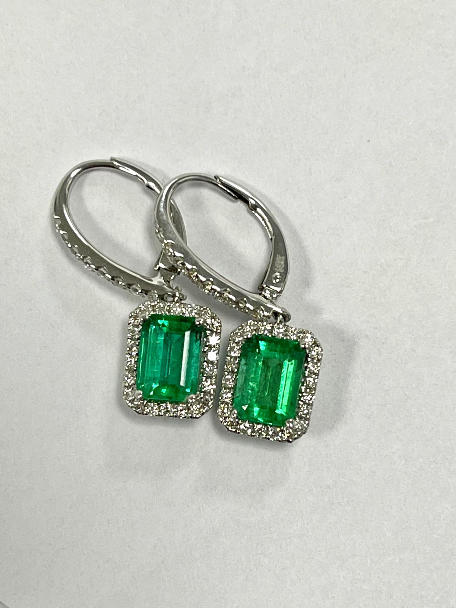 1.80 Carat Zambian emerald cut emerald set in 18k white gold earrings with 0.47 carat Diamonds .