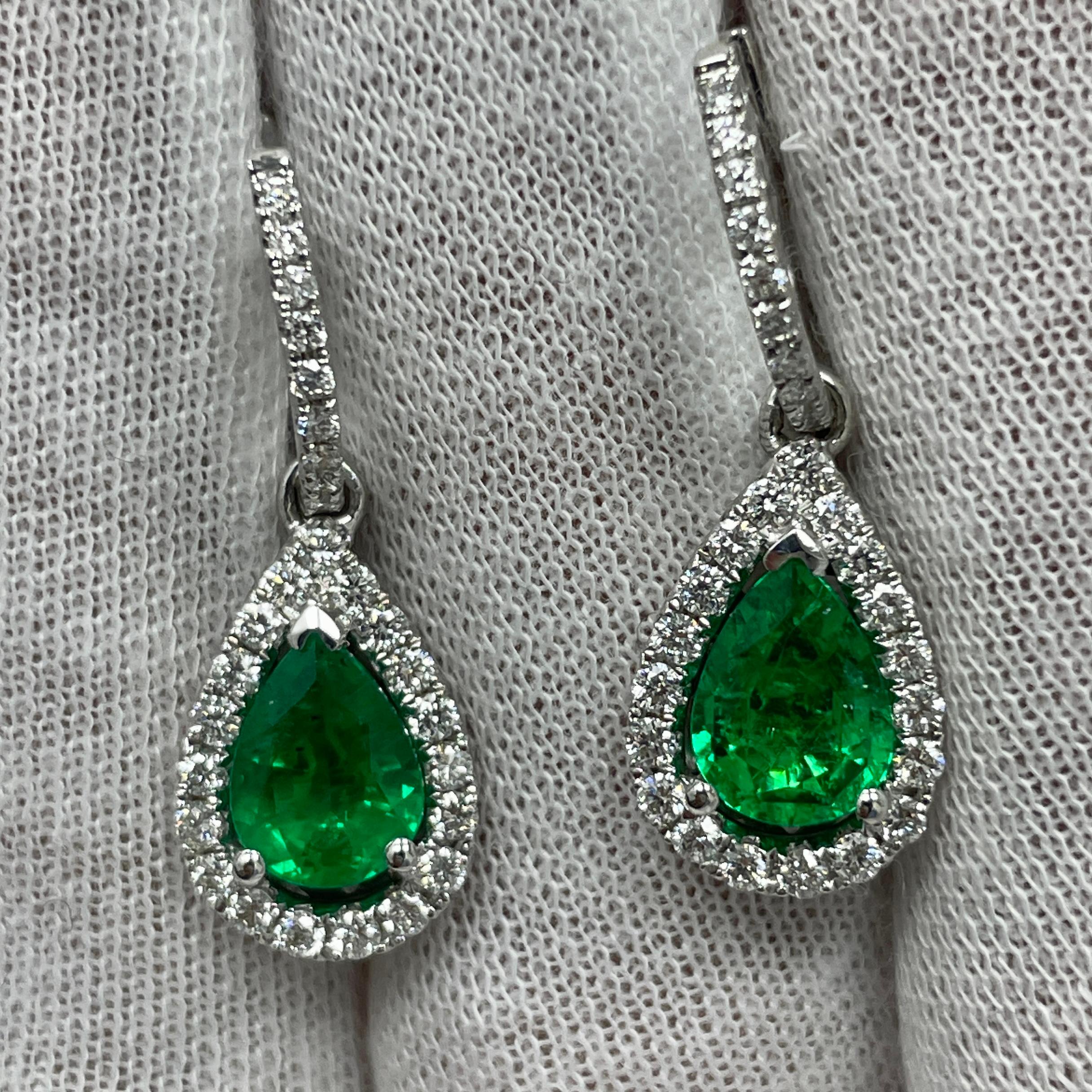 These dangling 18K white gold earrings carry .78Ct of brilliant white diamonds and 1.80Ct of stunning matching pear shape emeralds