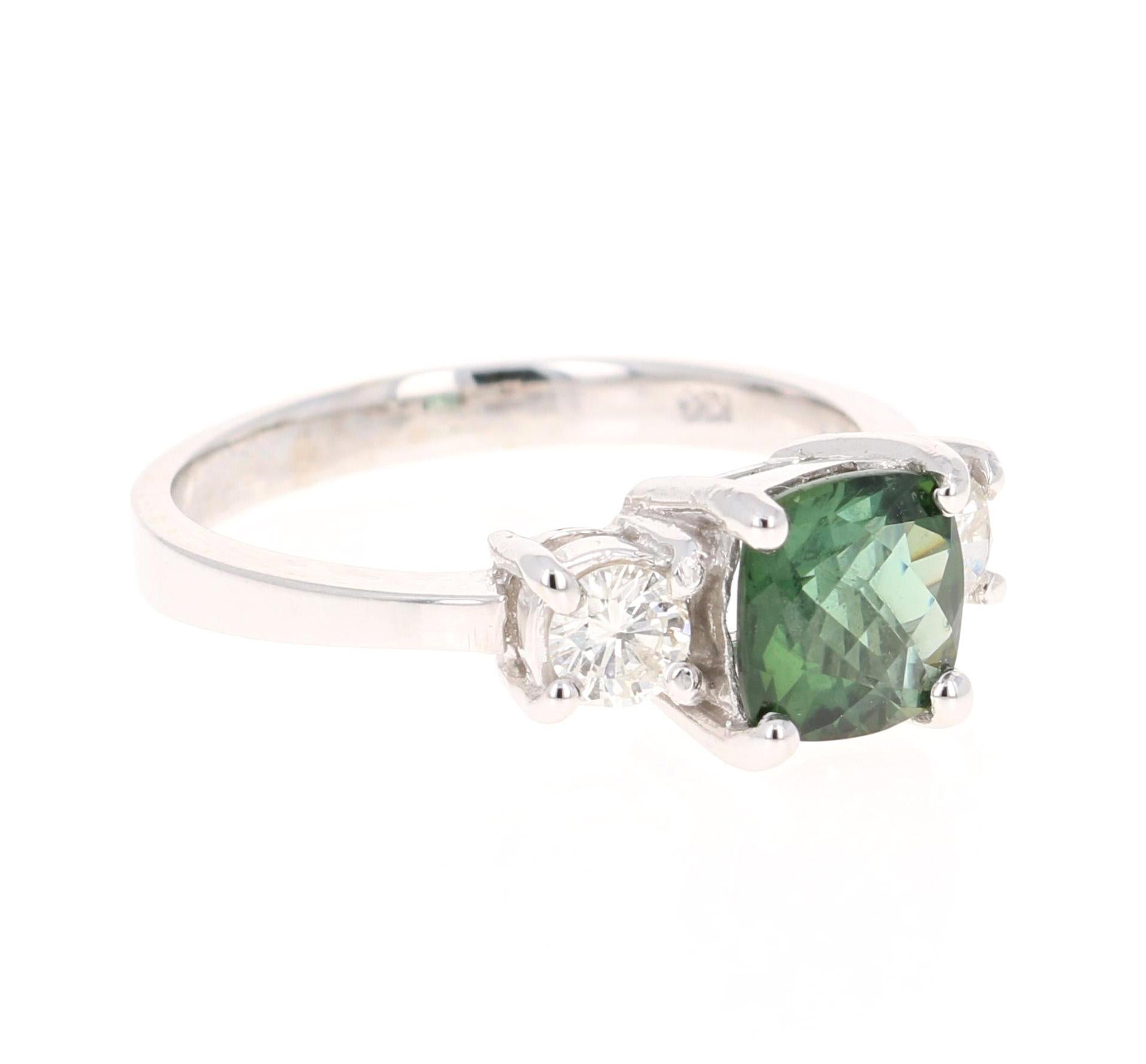 This ring has a mesmerizing Cushion cut Green Tourmaline weighing 1.42 Carats and 2 Round Cut Diamonds weighing 0.38 Carats. The total carat weight of the ring is 1.80 Carats. 

It is set in 14K White Gold and weighs approximately 3.6 grams. 

The