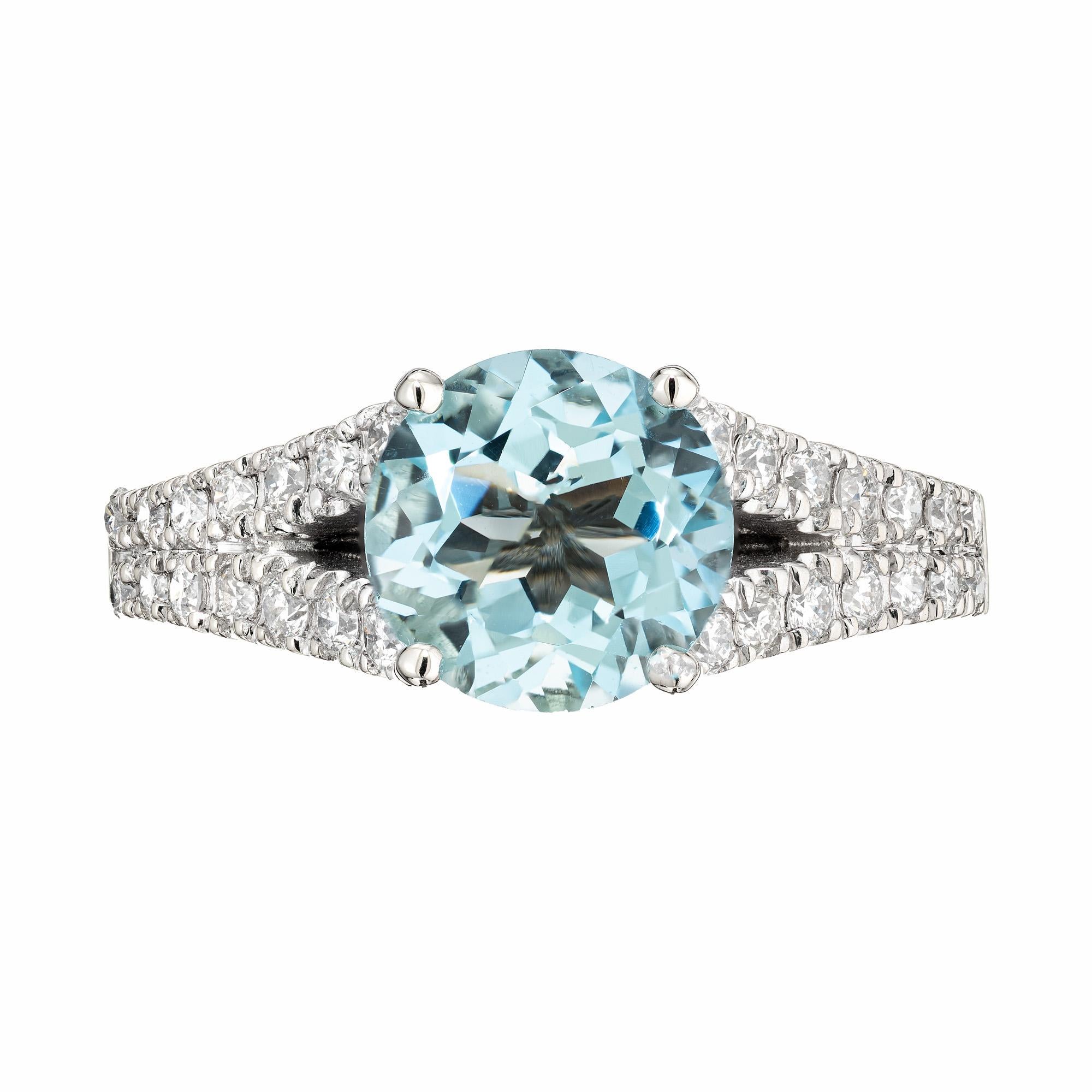 Natural Aqua and diamond 14k white gold split shank engagement ring. Mounted with a 1.80 carat round Aqua center stone, this split shank setting has two rows of full cut round diamonds along both shoulders and the shank. The bright light blue