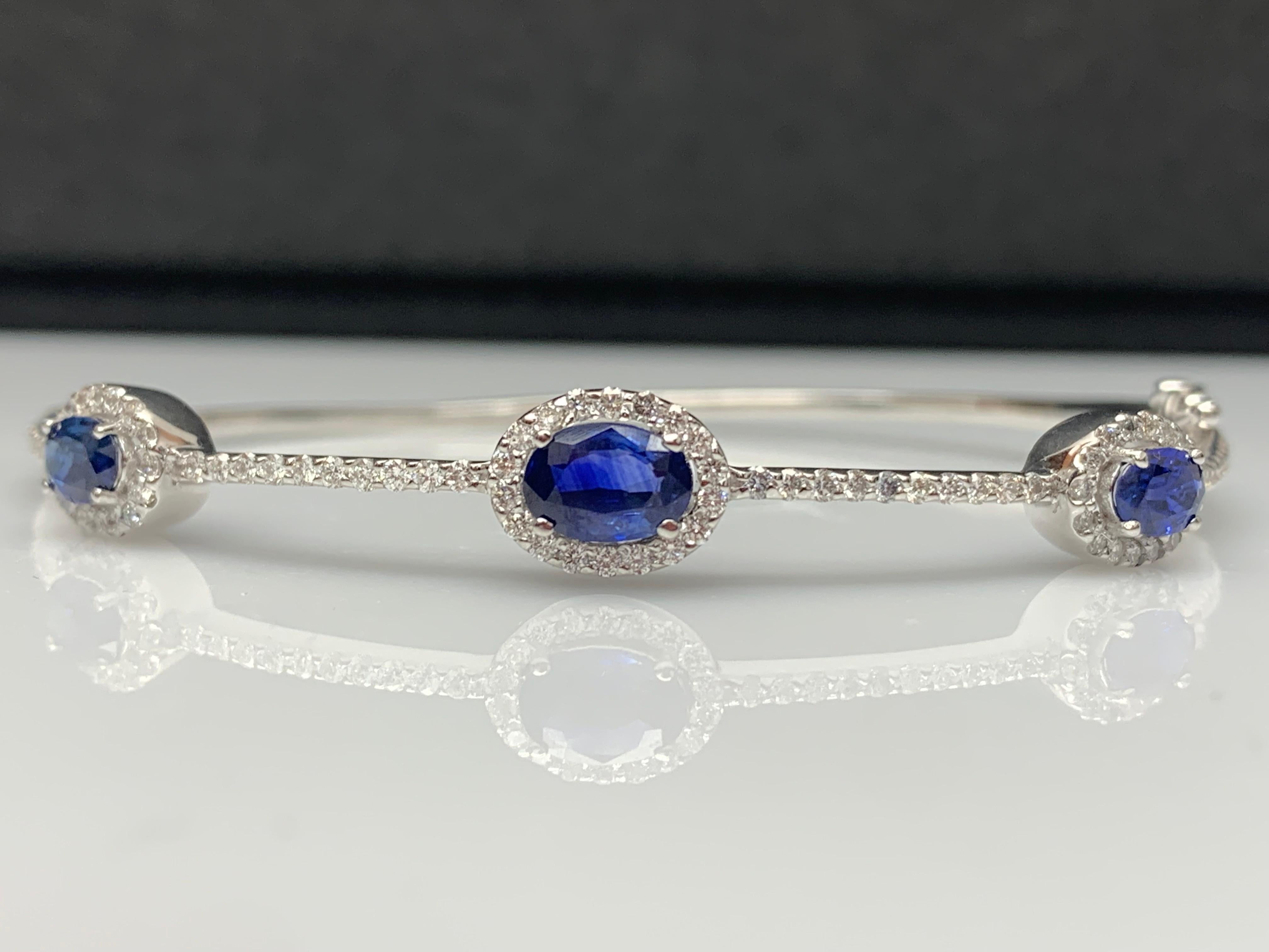 A unique and fashionable Sapphire bangle showcasing 3 oval cut Blue Sapphires weighing 1.80  carat and 90 brilliant diamonds weighing 0.87 carat in total.  Made in 14k white gold.

Style available in different price ranges. Prices are based on your