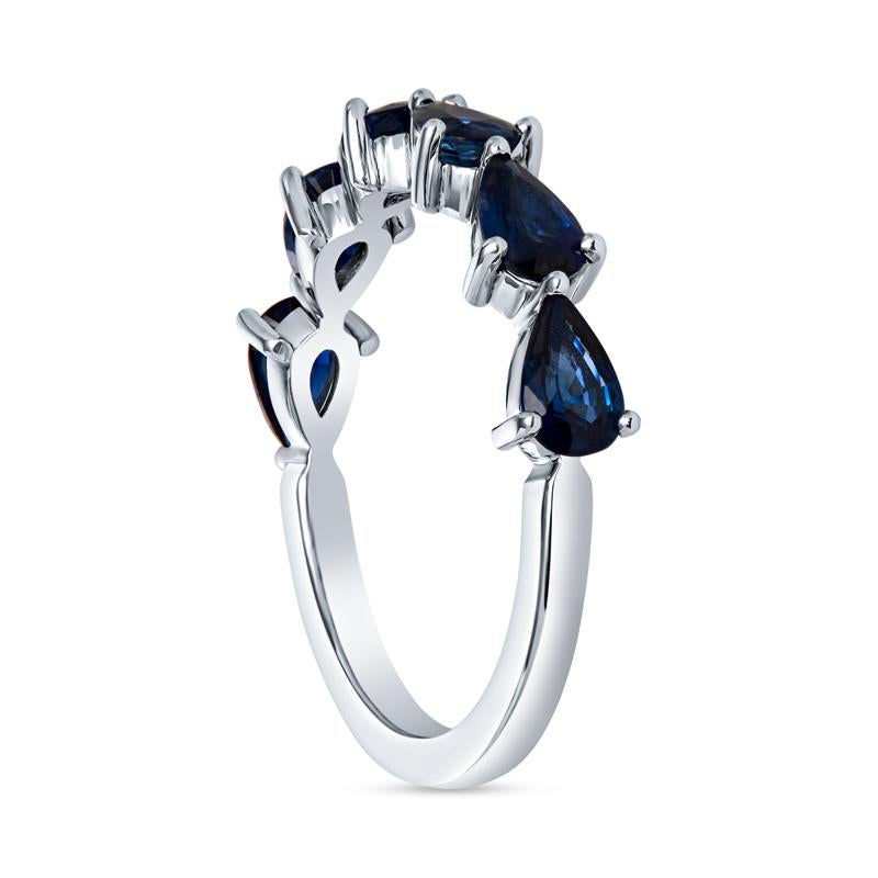This chasing pear band features 1.80 carat total weight in natural blue sapphires set east west that go halfway down the band. It is set in 18 karat white gold. Wear alone, with your engagement ring or layer with your other favorite bands. This band