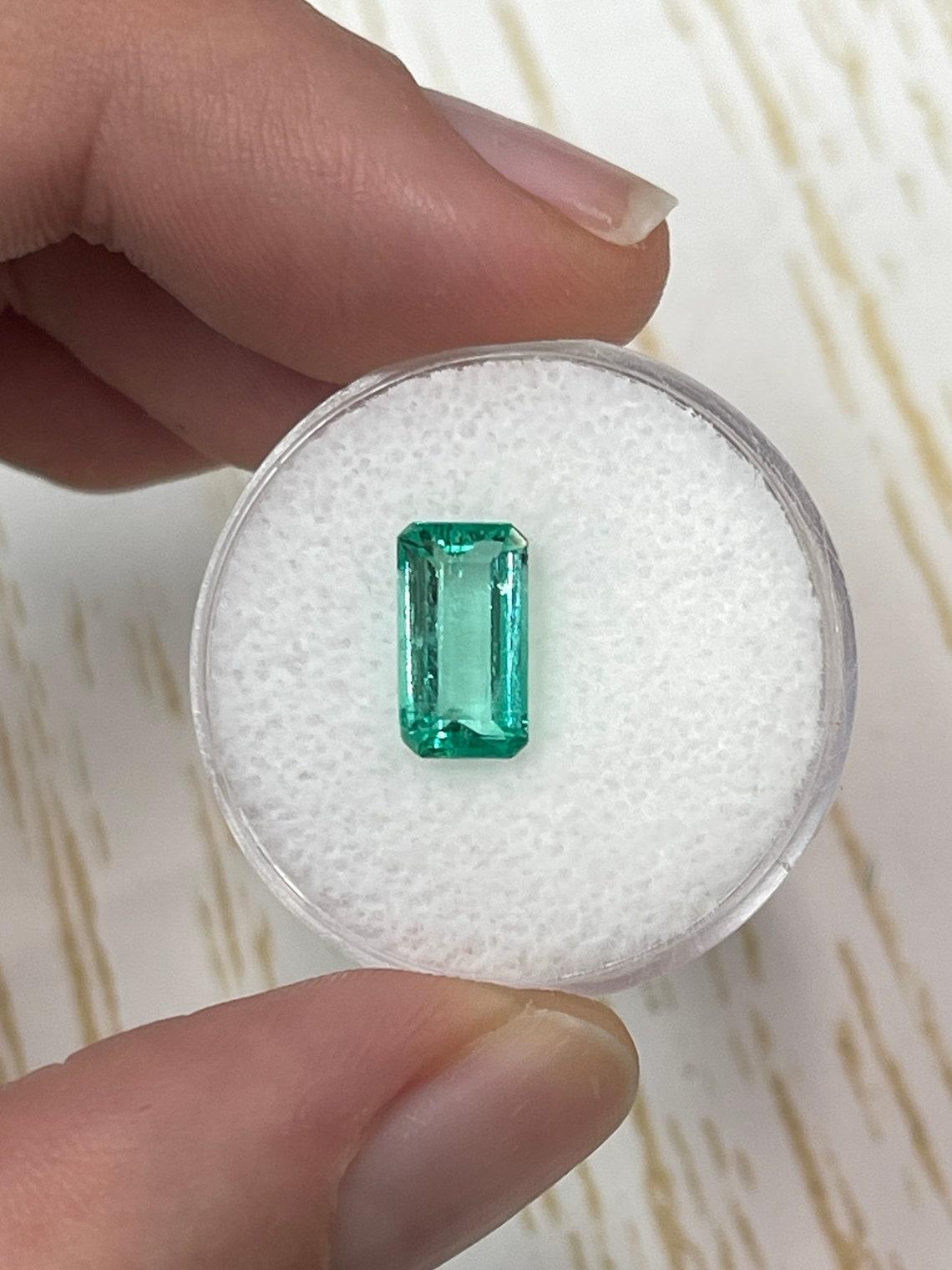 Stone: Emerald
Weight: 1.80-carats
Shape: Emerald Cut
Clarity: Transparent
Luster: Excellent
Color: Medium Bluish Green
Measurements: 10.29mm x 5.69mm x 4.01mm
Geographic Origin: Colombia
Treatment: Natural, Oiling

Comments: Due to their growth