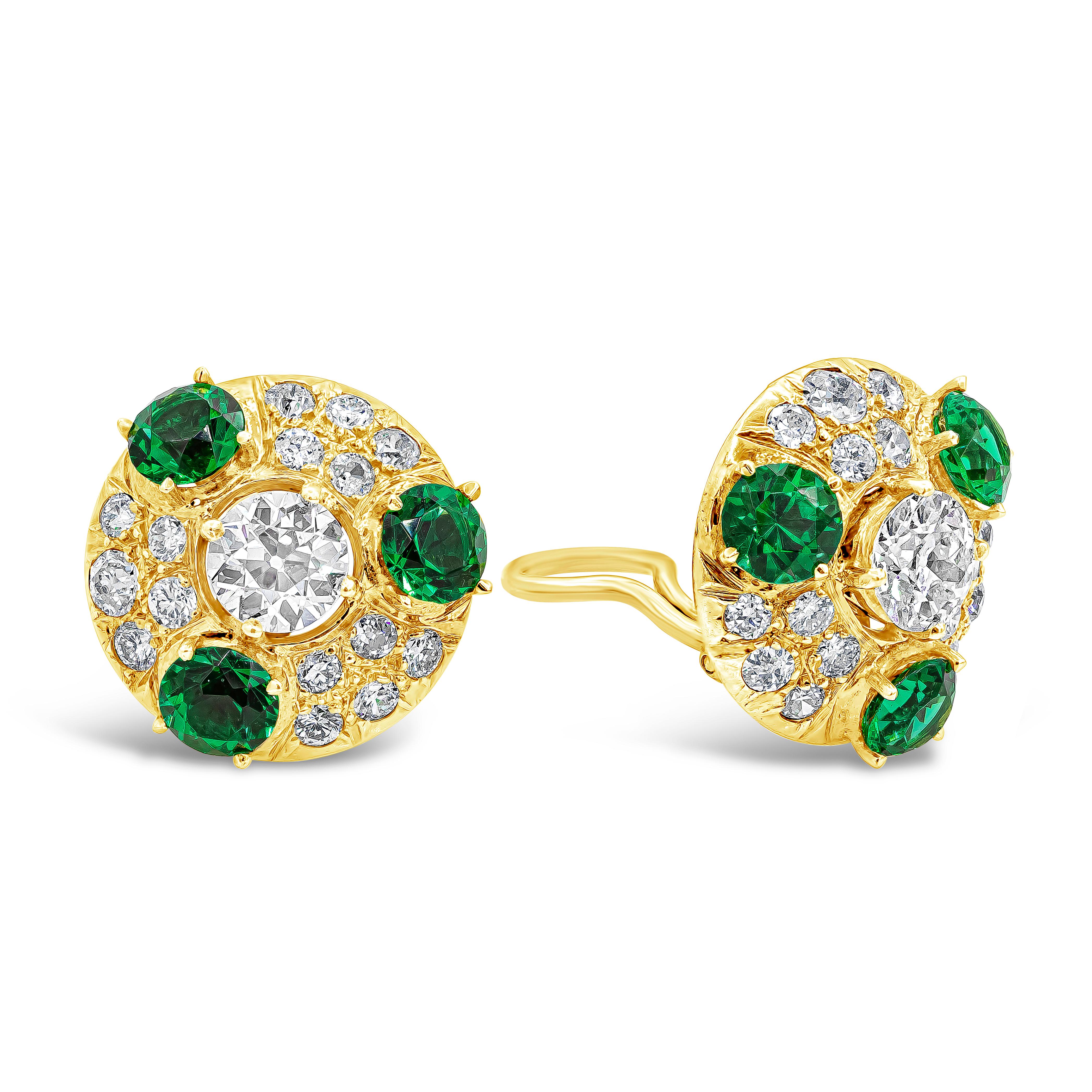 This simple but elegant clip on earrings showcasing two old european cut center stone weighing 1.80 carats total. Accented by smaller old european diamonds and three imitation green emeralds. Accent diamonds weigh 1.35 carats total. Made in 18K