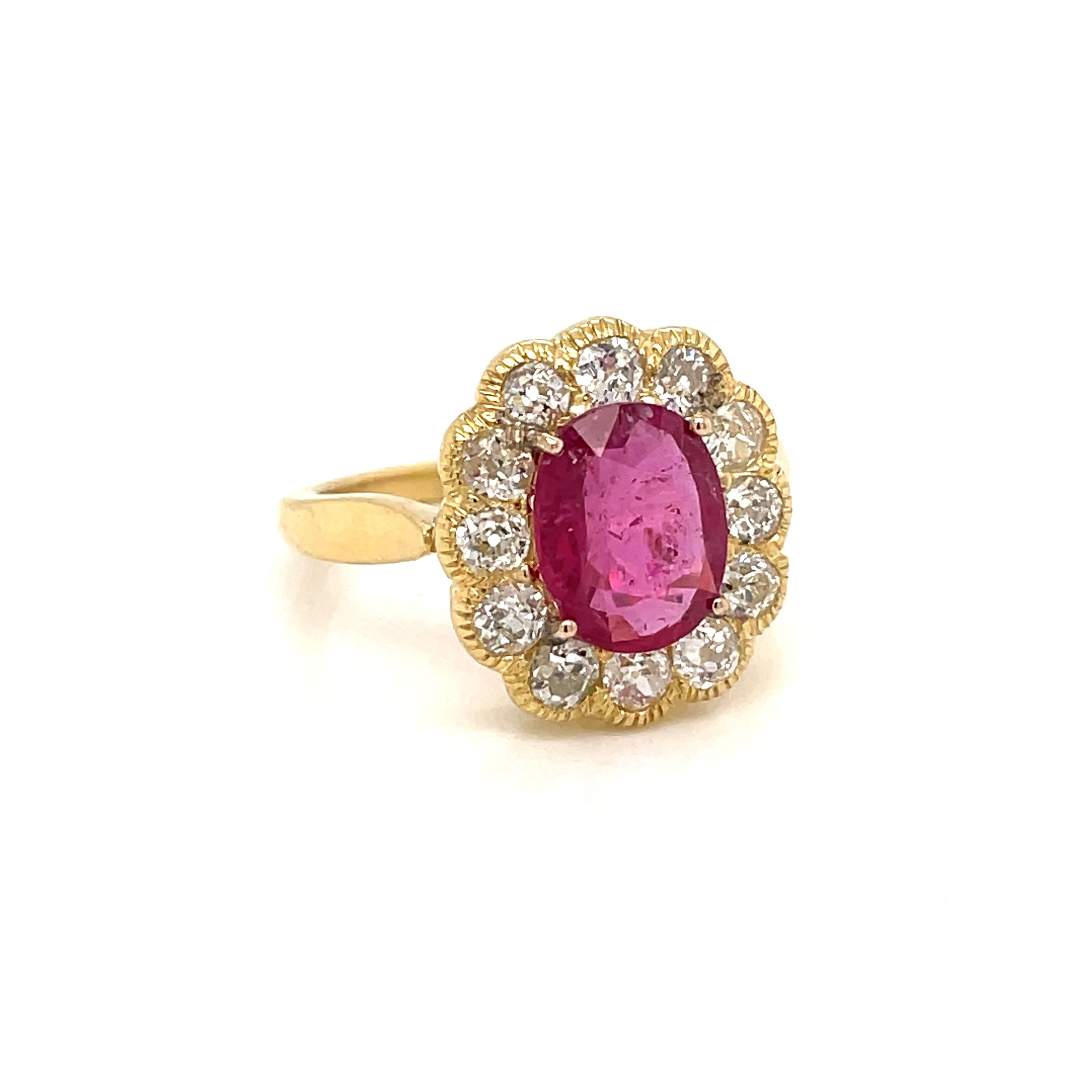 Antique 18K rose Gold Ruby and Diamond ring. 
The cluster style ring is centered with an approximately 2.50 carats stunning oval ruby, Thailand origin, accented by an halo of sparkling old mine cut diamonds weighing approx. 1.80 carats total. 
Late