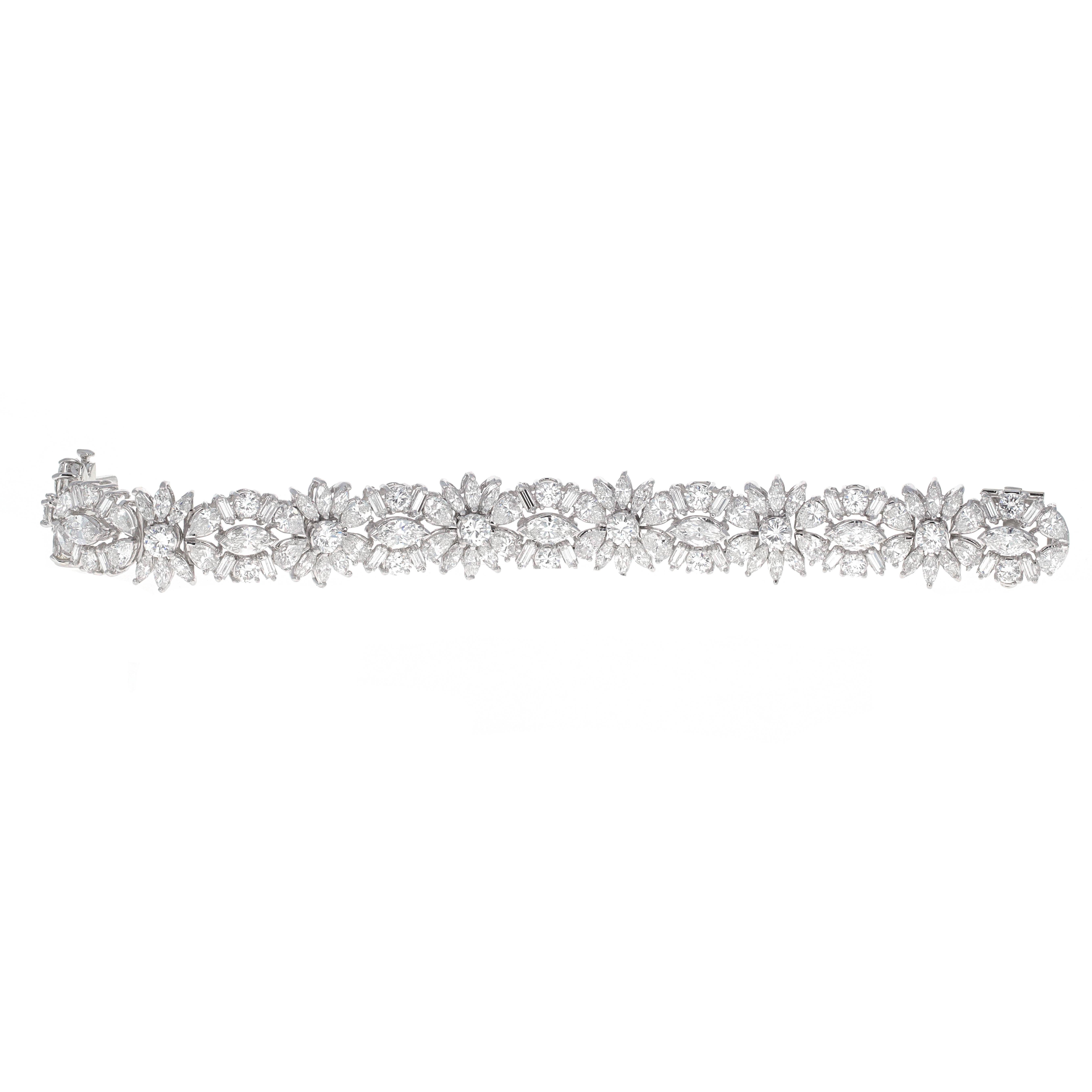 Beautiful estate 18 karat white gold fancy shape diamond tennis bracelet. The bracelet has 126 white diamonds weighing an estimated 18.00 carats total weight. The diamonds are round brilliant, marquise, pear and baguette shaped. 

The bracelet is in