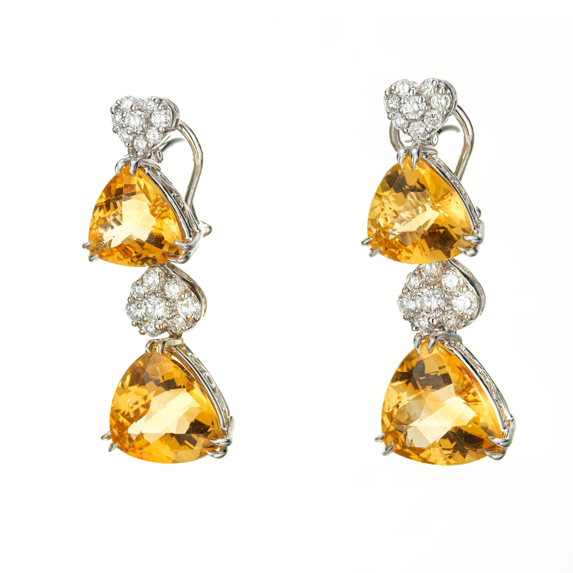 Citrine and diamond dangle clip post earrings. 4 fantasy cut triangular yellow citrines set in 18k white gold with 32 round brilliant cut accent diamonds. 

4 Triangular yellow citrines, approx. total weight. 18.00cts   11.3x7.3mm  and  14x8.5mm
32