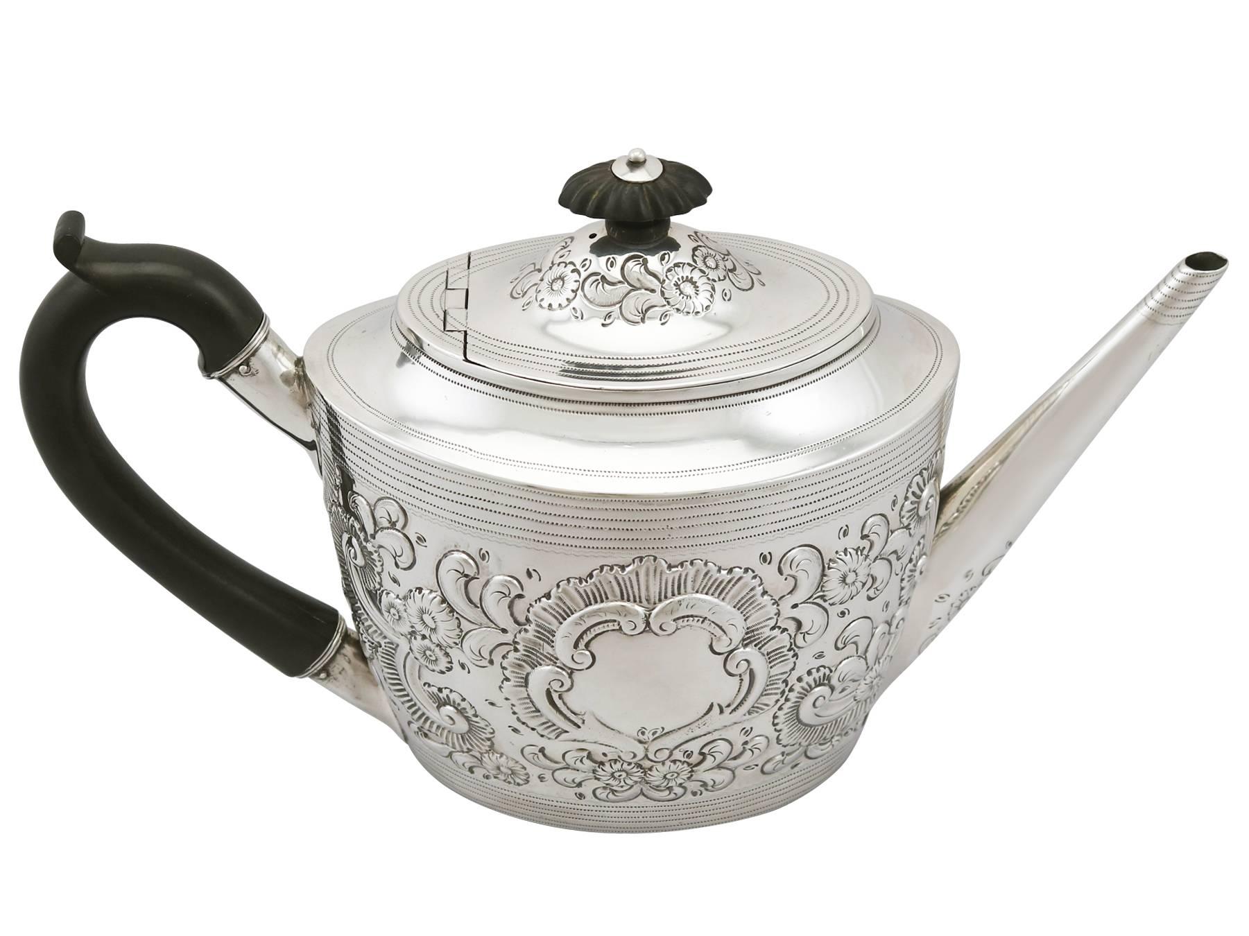 An exceptional, fine and impressive antique Georgian English sterling silver teapot; an addition to our silver teaware collection.

This exceptional antique George III York sterling silver teapot has an oval tapering form.

The body of the