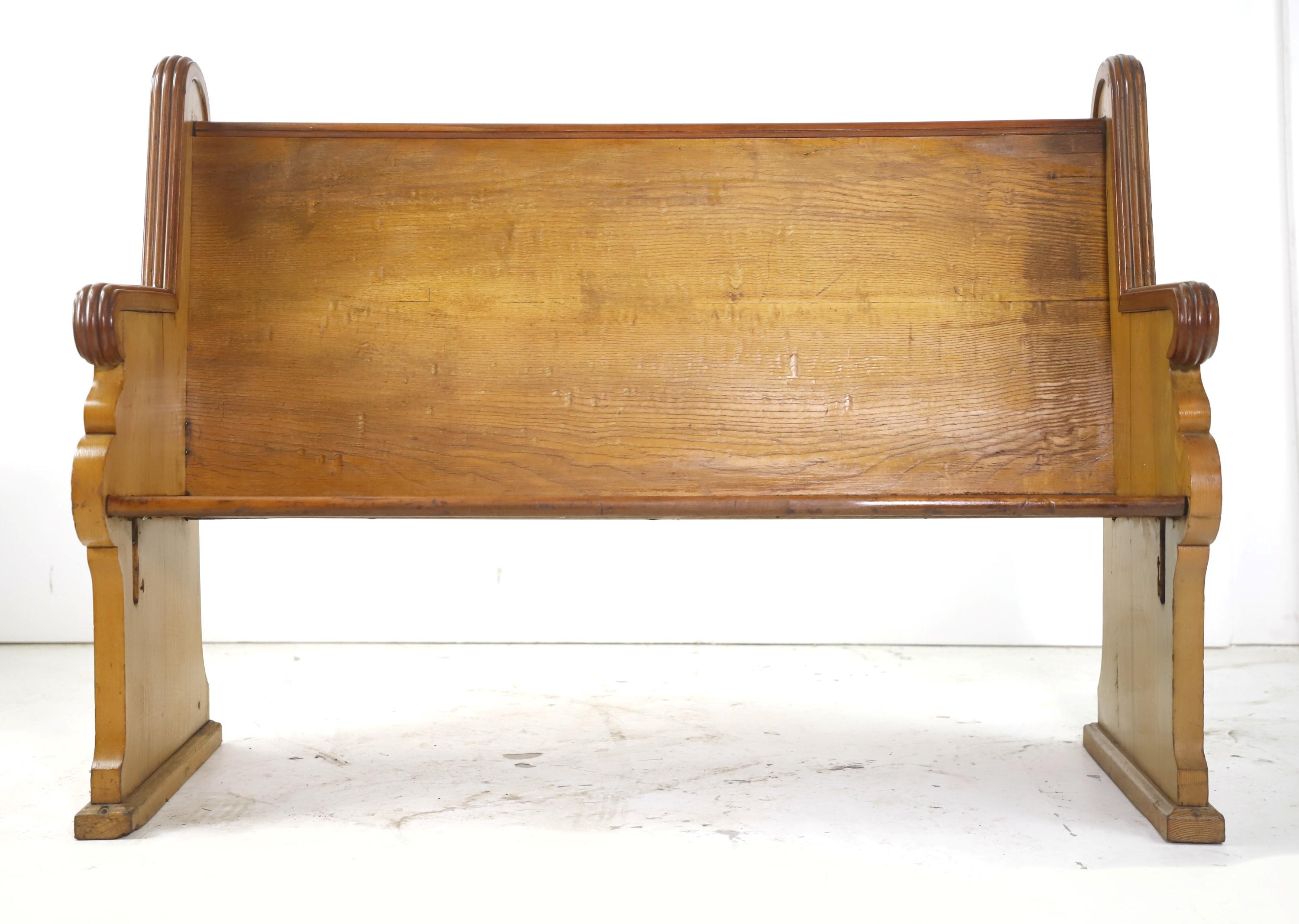 Late 1800s church pew made from solid oak. Finished in a light stain. This features a hand carved Gothic design with Bullseyes on the corners. Please note, this item is located in one of our NYC locations.