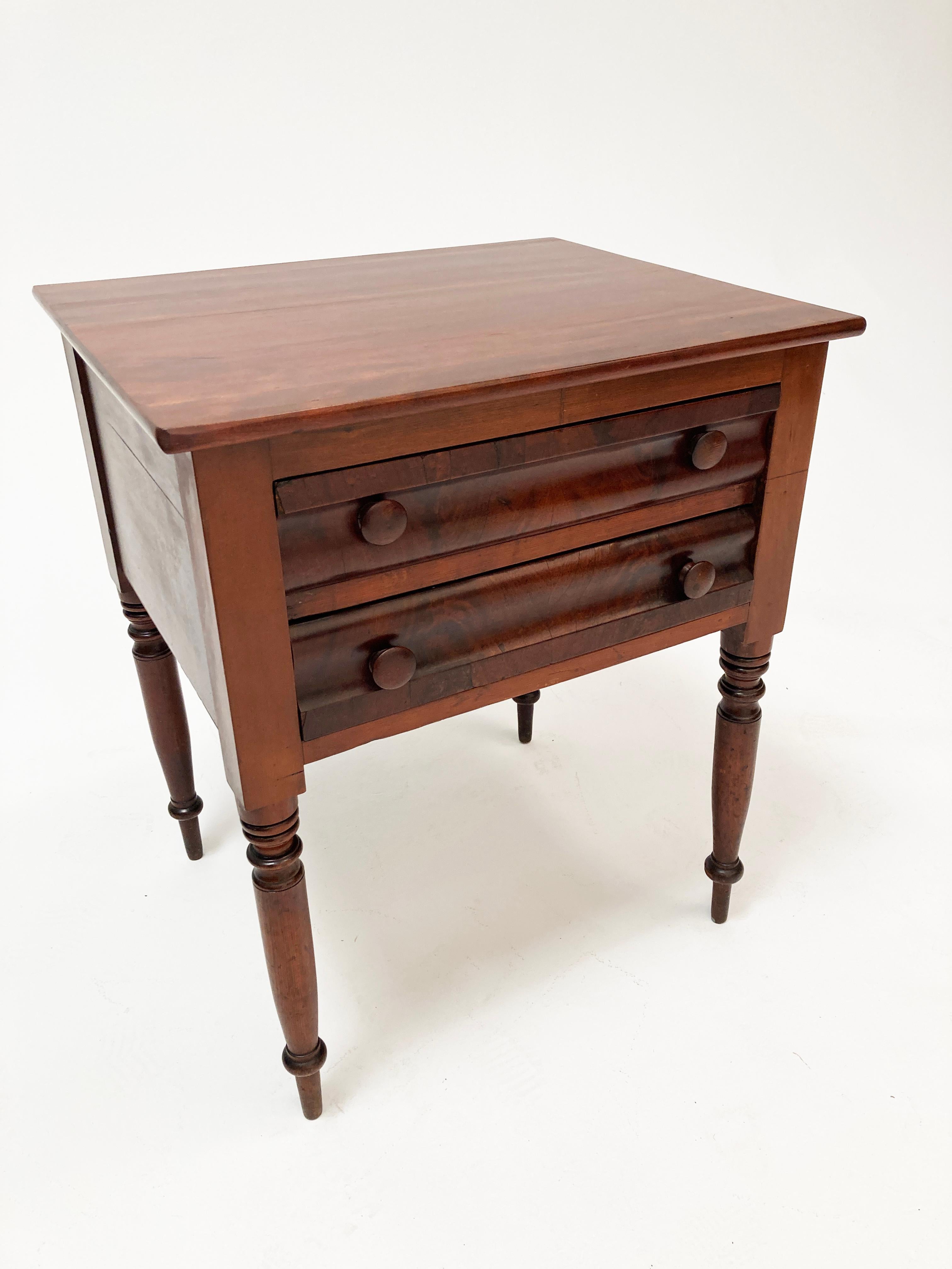 This gorgeous American Federal period table is a beautiful reflection of the early 1800's. With hand turned legs, unique irregular lines and curves that display a master builder's hand tools, and the warmly stained and richly figured mahogany wood,