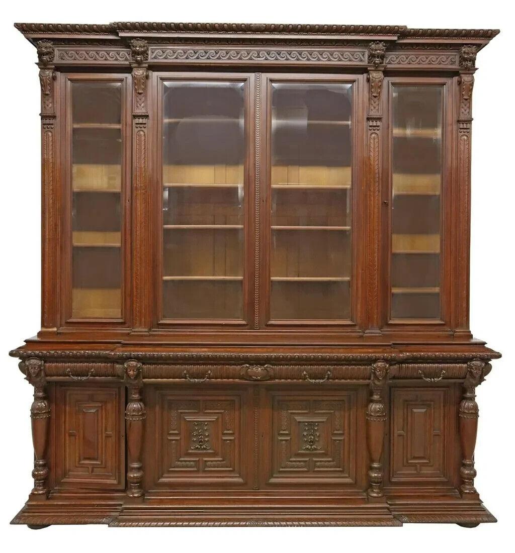 Stunning Antique Bookcase, Breakfront, Monumental, French, Walnut, Beveled Glass, 19th Century, 1800s!

Monumental French walnut breakfront bookcase, 19th Century, molded cornice, frieze with carved lions masks, four glazed doors with beveled glass