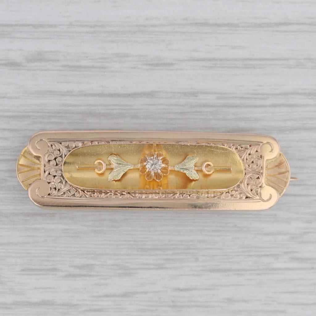 This beautiful antique pin dates from the 1850s - 1860s.

Gemstone Information:
- Natural Diamond -
Carats - 0.04ct 
Cut - Round Brilliant
Color - Light Brown
Clarity - SI1

Metal: 18k Yellow & Green Gold (XRF tested)
Stamps: Signed CM on