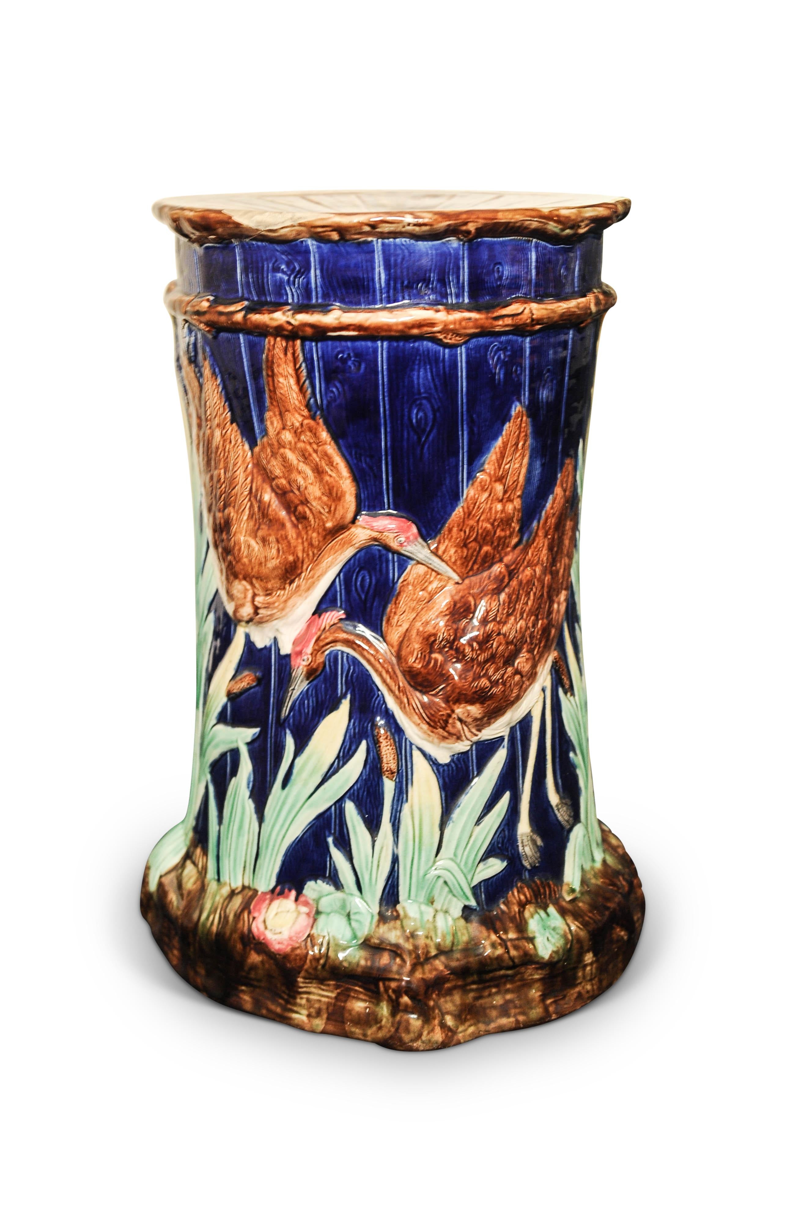 A late 19th century Art Nouveau Thomas Forester Majolica ceramic garden stool in the Numidian crane pattern, painted with a cobalt blue ground with raised cranes and foliage, with a pierced seat to the top, circa 1881-1900.

Thomas Forester & Sons