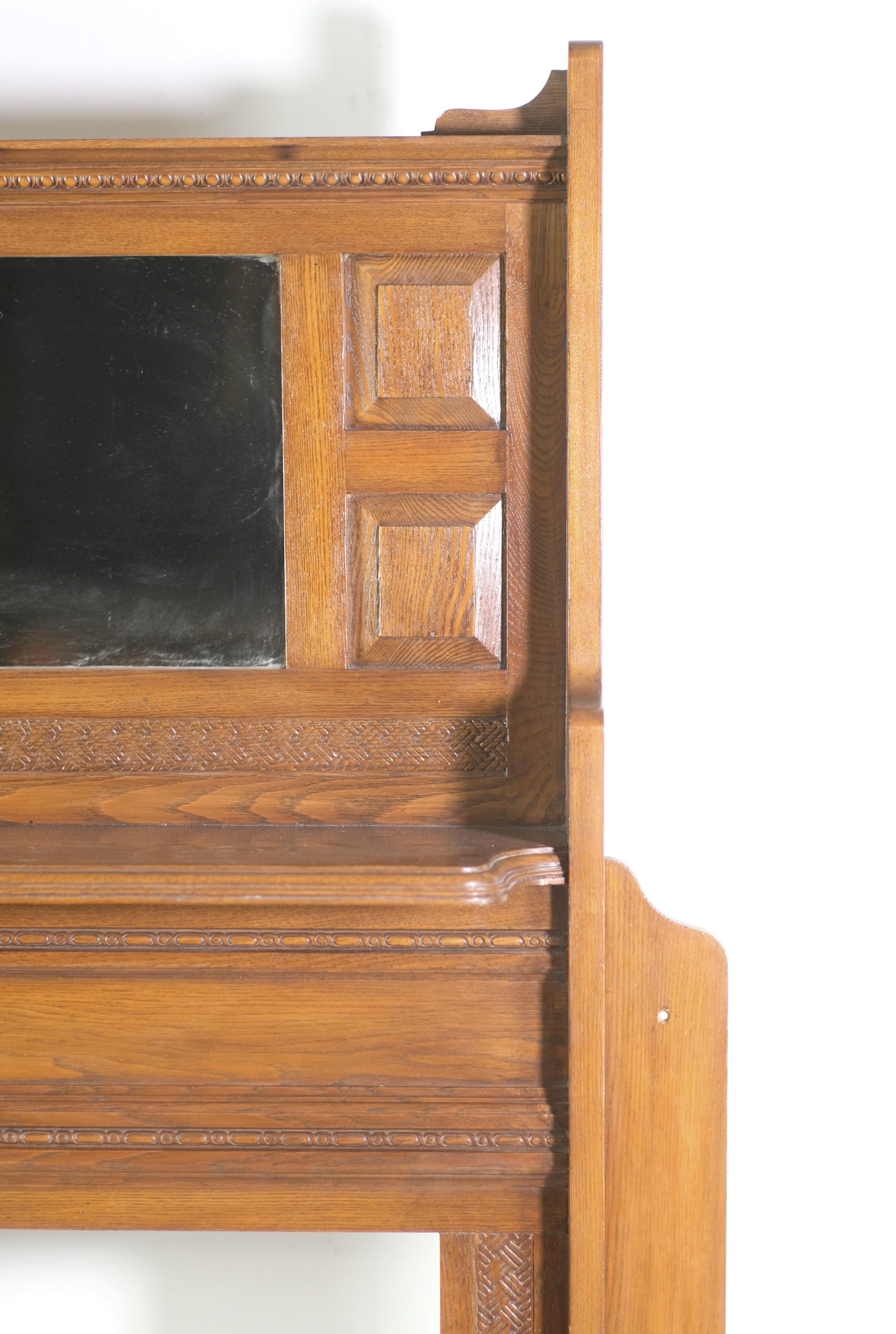 Late 1800s solid ash mantel featuring a basket weave pattern. Original distressed mirror. Fireplace opening has been reinforced and made sturdy with plywood. Manufactured by The Bradley & Currier Co, Ltd, NY, NY. Please note, this item is located in