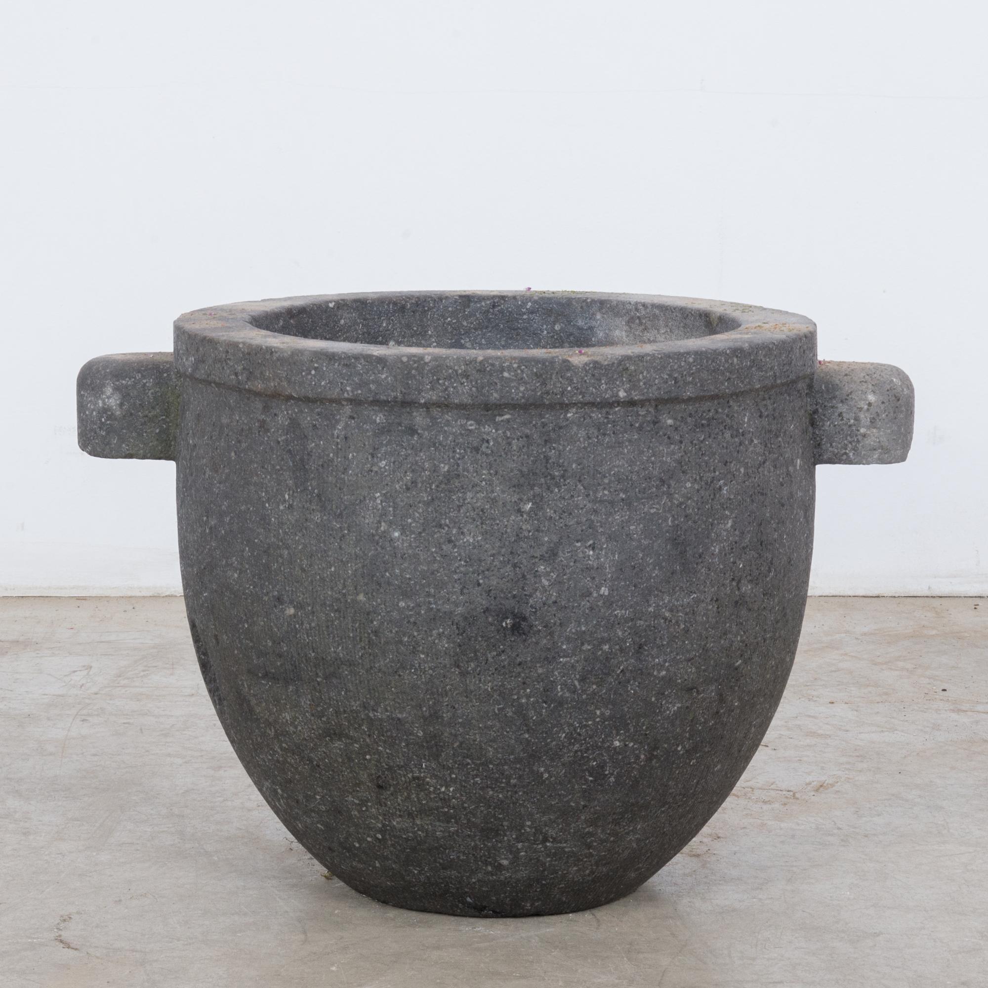A mortar made of black stone from Belgium, circa 1800. A smooth stone vessel with two blunt handles and a gentle rim. A very subtle texture speaks to the craftsmanship with which this piece was made. The stylish, Minimalist shape, coupled with its