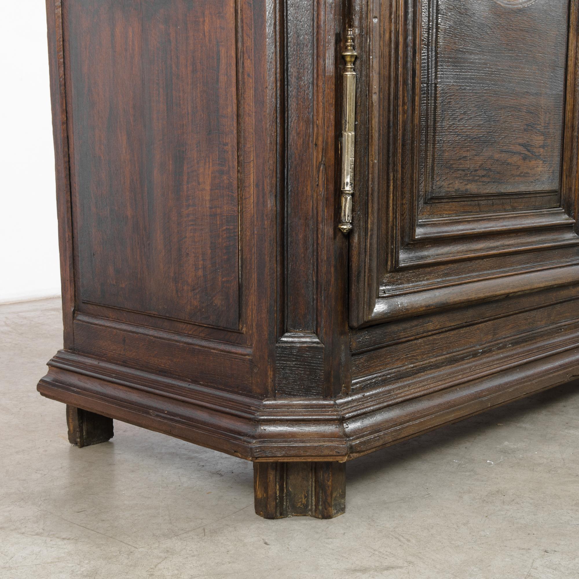 Step into the grandeur of the 1800s with the Belgian Wooden Cabinet, a testament to the enduring elegance of the past. Impressive in stature, this cabinet boasts crown molding at the top, adding a regal touch to its design. The dark patina, exuding