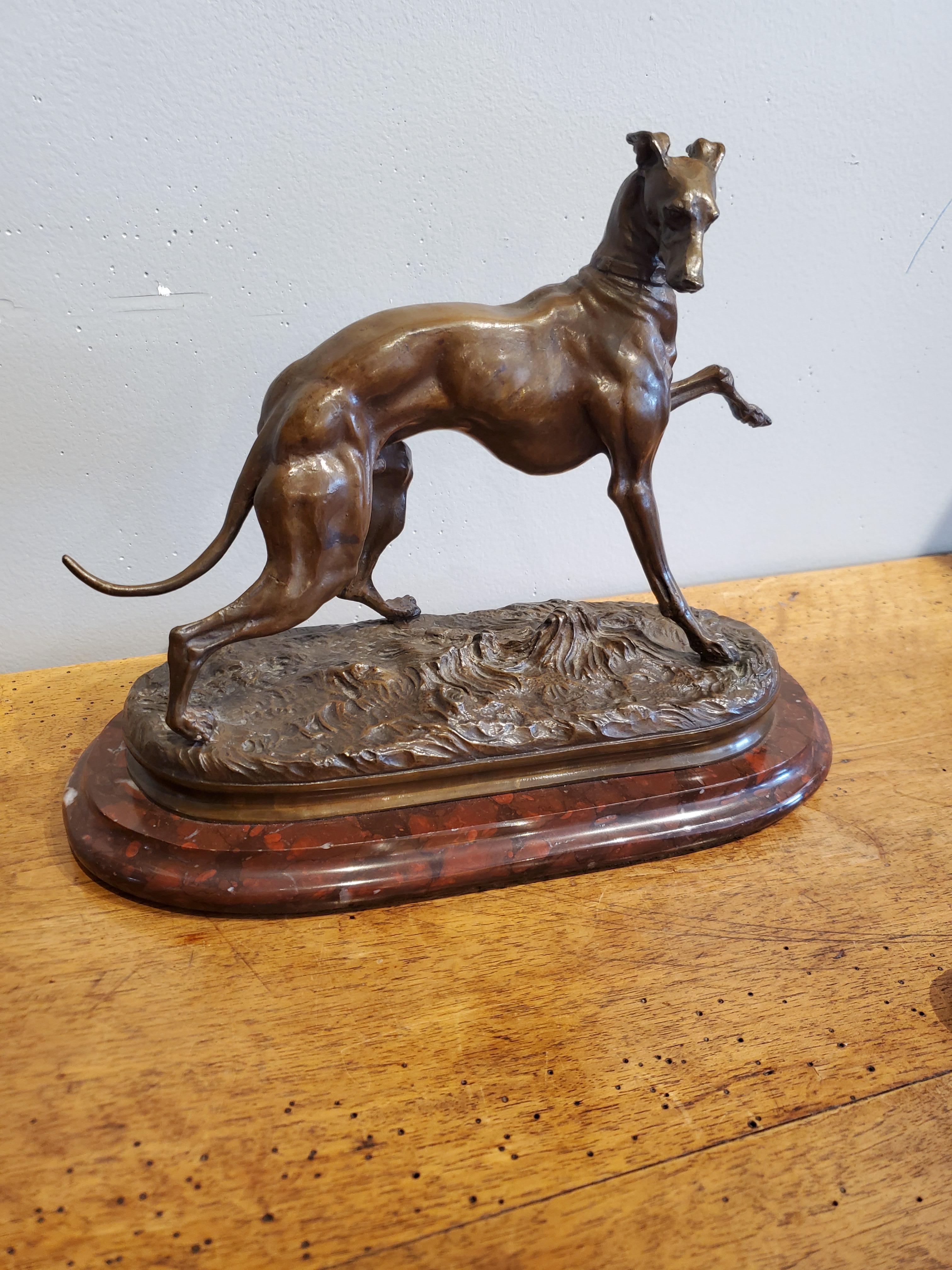 This bronze Greyhound dog figurine is beautifully smooth, sleek, and sculpted after Pierre Jules Mene during the late 1800s. The sculpture is stamped 