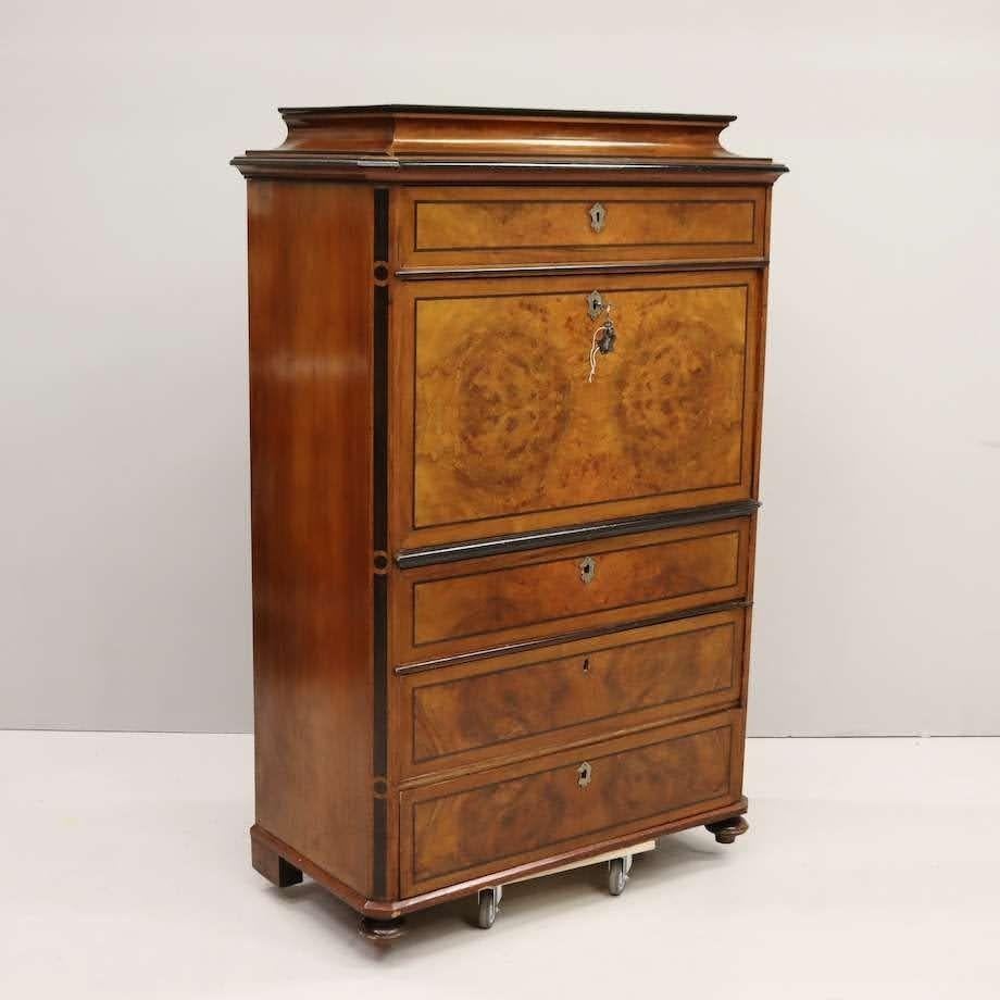 Tall secretary from 1800s. Beautiful burl wood veneered drawer and cabinet facing with detailed inlay and glossy black trim throughout the piece. Original hardware (except one drawer missing hardware). Minor surface scratches.
 
H 60