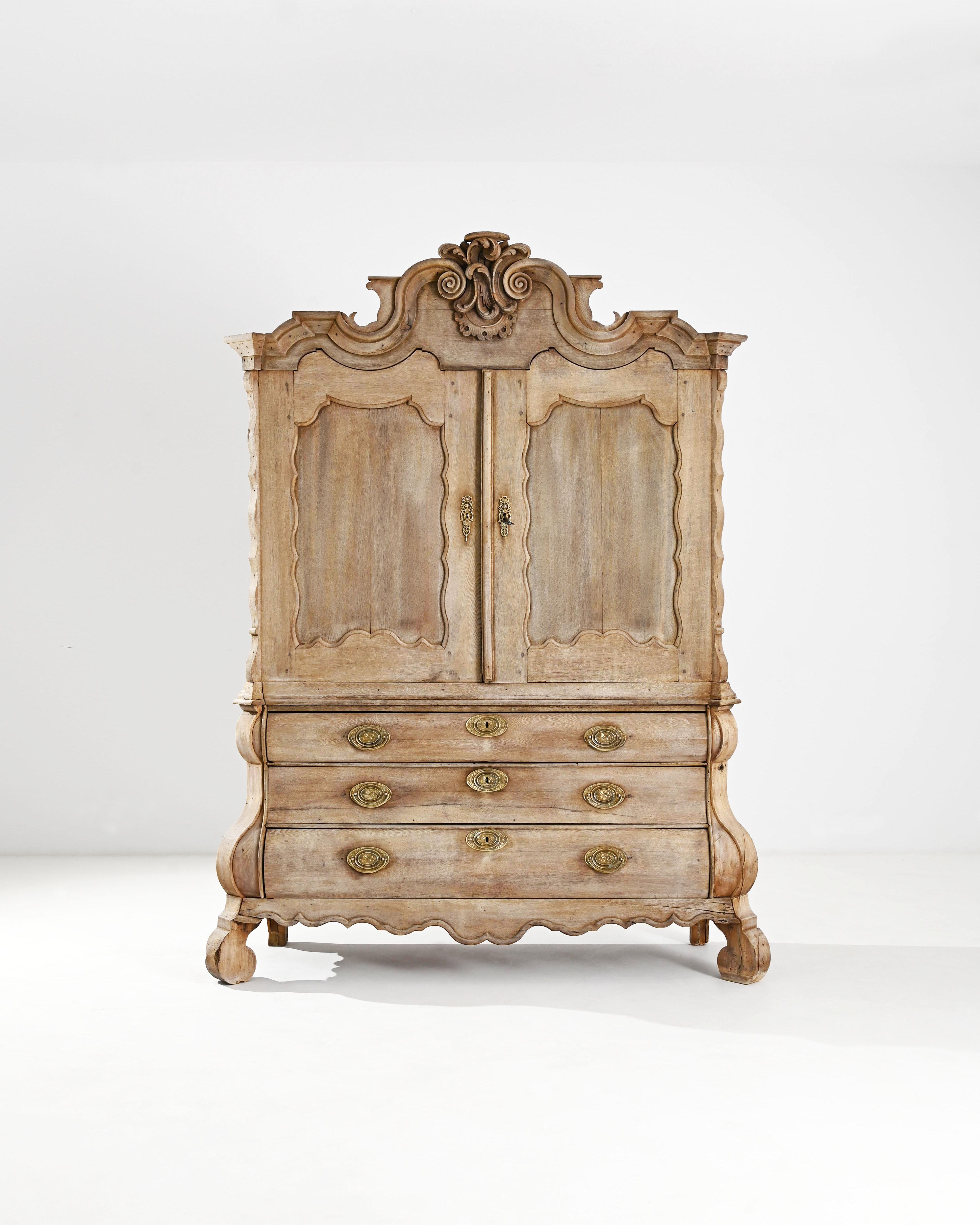 A magnificent baroque cabinet in natural oak. Made in the Netherlands circa 1800, the exemplary cabinetry on display here is a testament to the carpenter’s skill. Eschewing straight lines, the design uses S-shaped curves to create a sense of volume