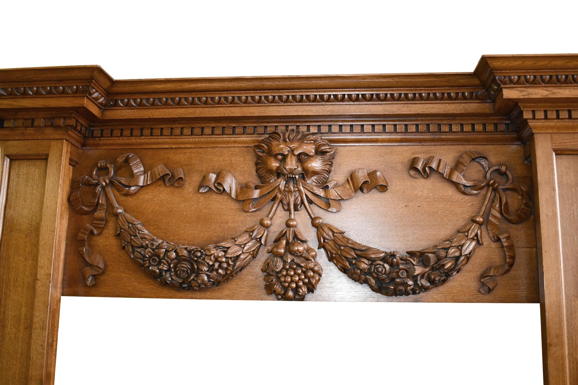 English Regency style oak mantel. Very large mantel, but not overly done, from the 1800s. It has a center lion motif with ribbon and swag details. Please note, this item is located in our Scranton, PA location.