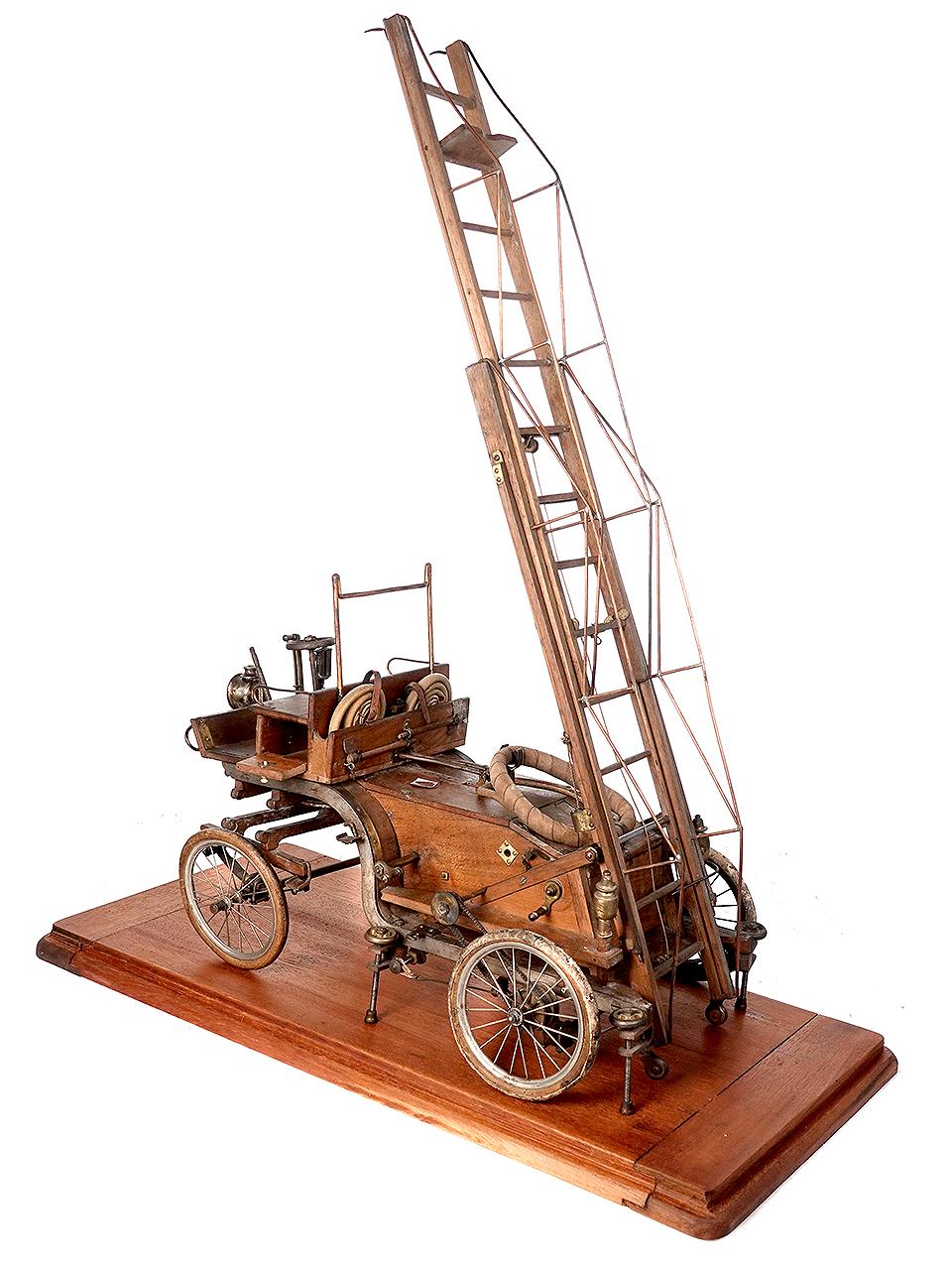 I have very little background on this item. I call it late 1800 but could be as late as 1910 because it may be a model of a very early self propelled ladder truck. I spent some time looking it over. This is really early and considering how fragile