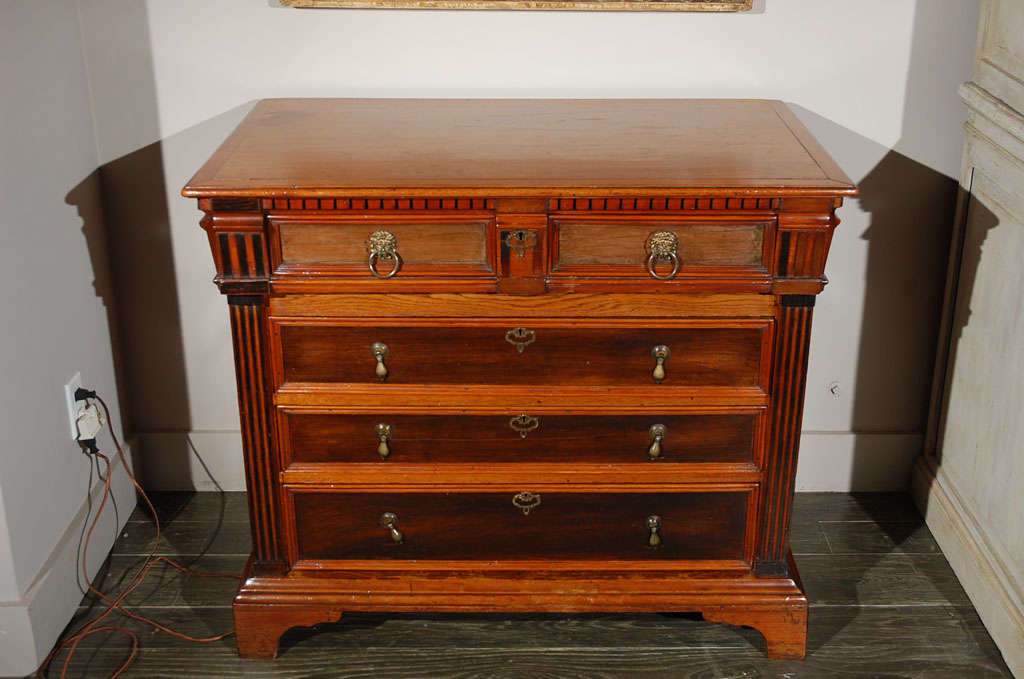 Early 19th-century Dutch fruitwood chest with five drawers, elegant brass hardware, a dentil carved frieze, fluted side pilasters, beveled side panels, and a bracket footed base. Substantial and handsomely designed. 

Netherlands, circa