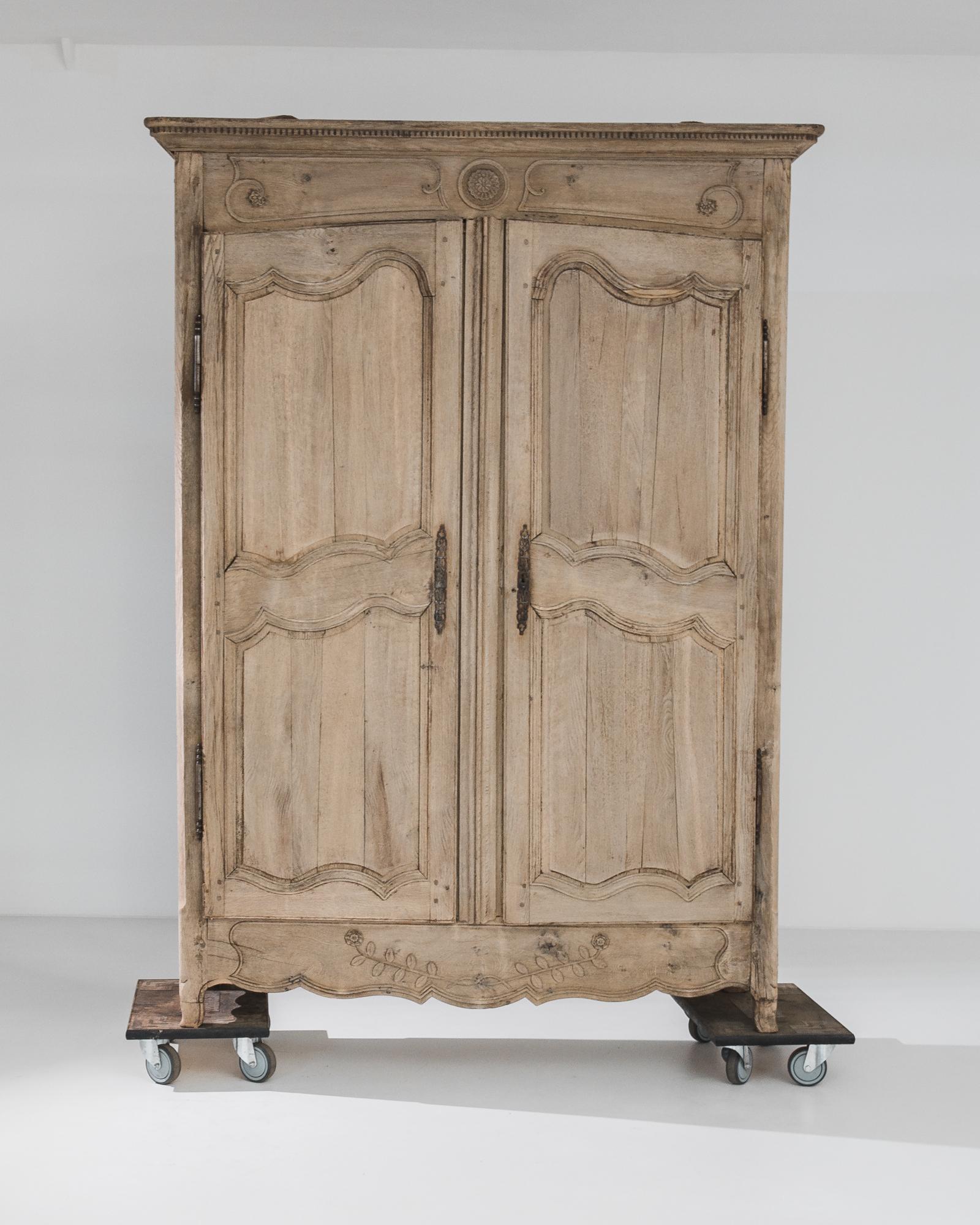 Transporting us to the refined interiors of 19th-century France, this bleached oak armoire from the 1800s stands as a symbol of timeless elegance and sophistication. Crafted with meticulous attention to detail, this piece embodies the exquisite