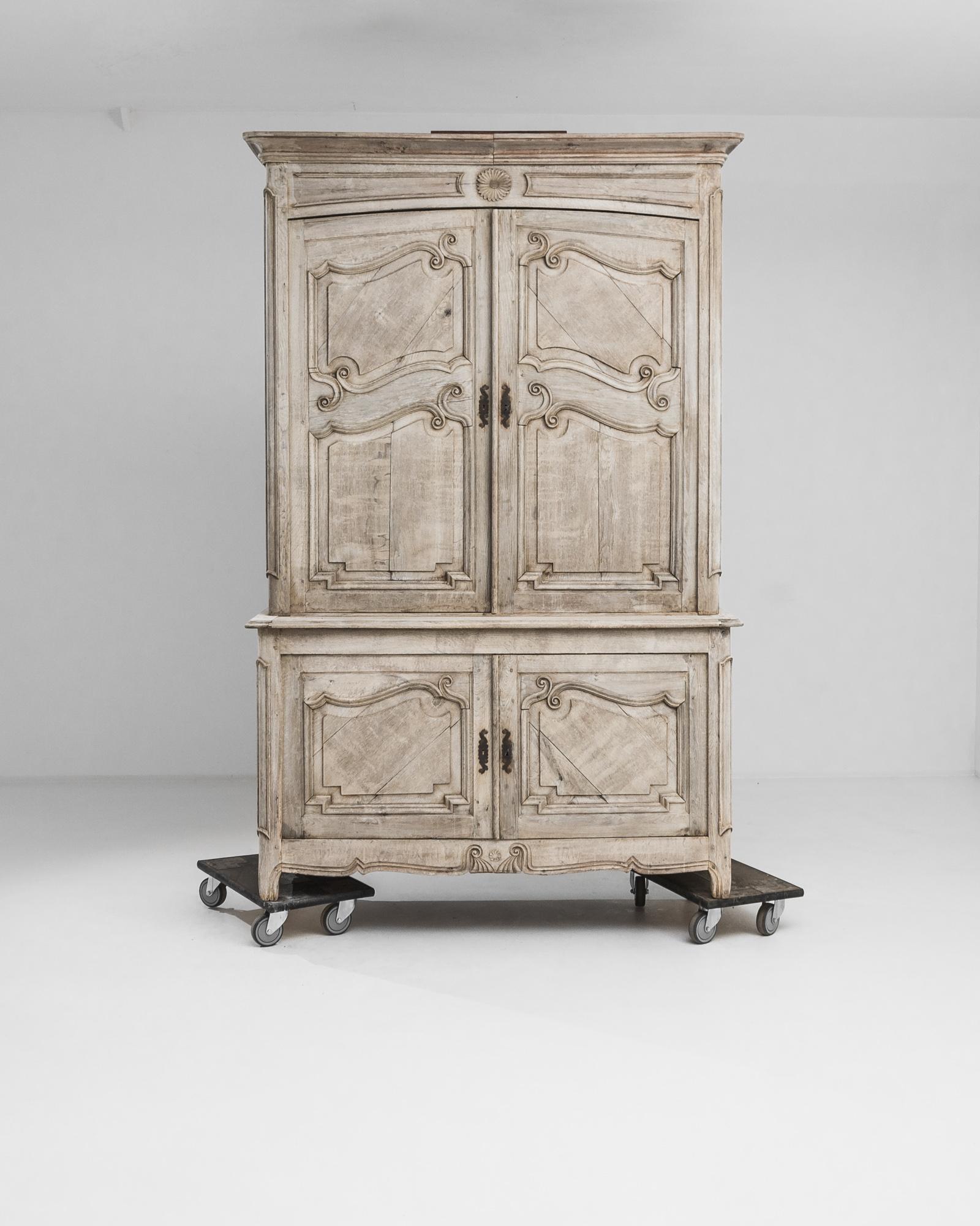 Emanate the charm of yesteryear with this 1800s French Bleached Oak Cabinet, a storied piece that marries storied craftsmanship with functionality. Its sun-kissed, bleached oak exterior bears the gentle caress of time, showcasing a natural grain