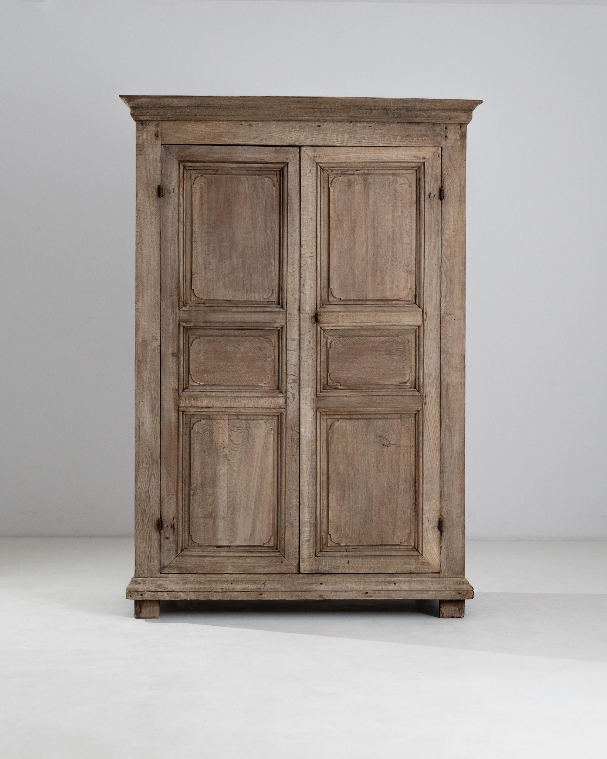 The clean, understated design of this antique oak cabinet gives it a perennial elegance. Made in France circa 1800, the discreet pegs of the mortise and tenon joinery are visible evidence of the masterful cabinetwork that has allowed this piece to