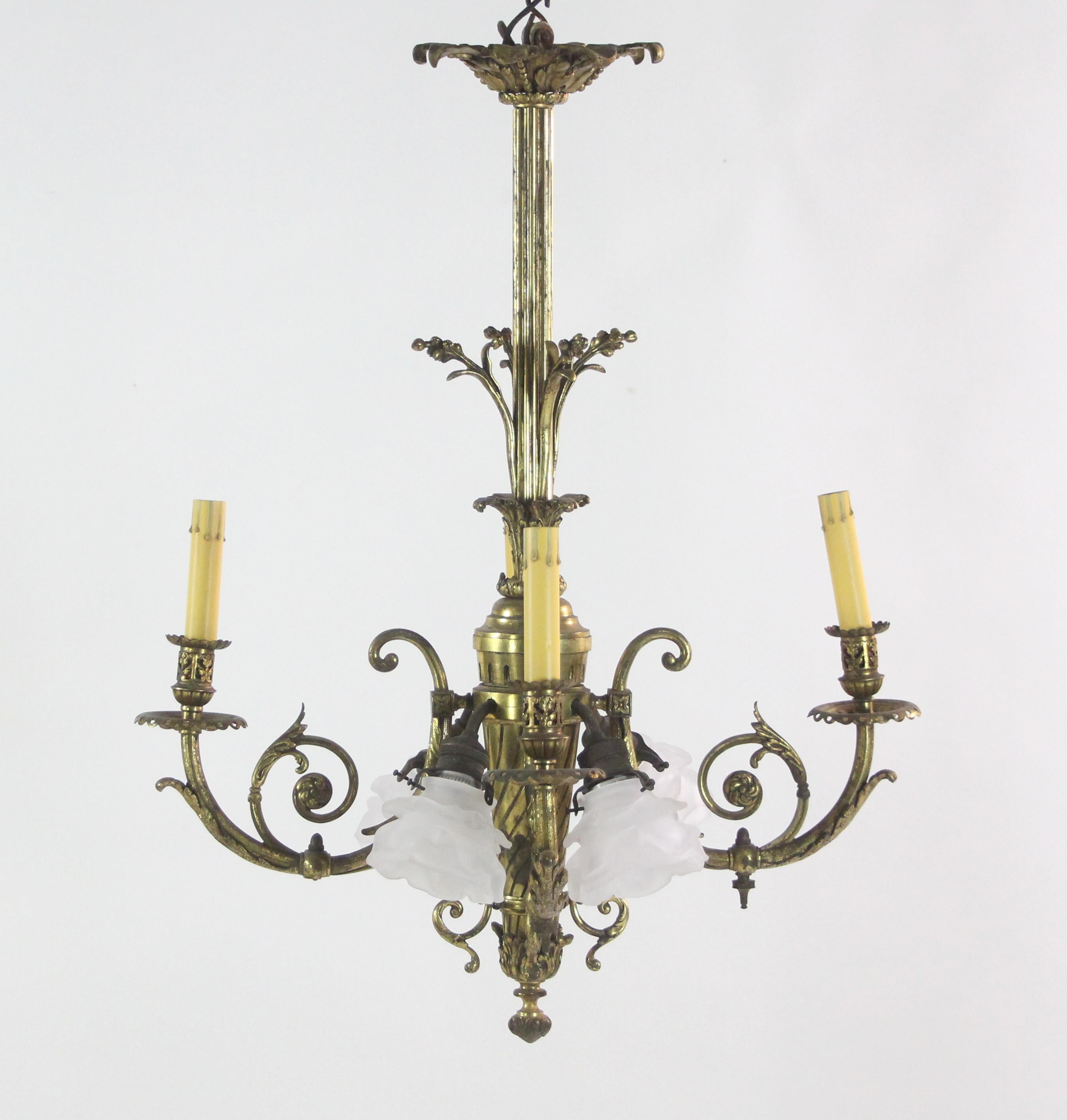 19th century French cast bronze chandelier with foliate details. It features four candlestick arms and four down lights with frosted floral shades, making eight lights total. This can be seen at our 400 Gilligan St location in Scranton, PA.