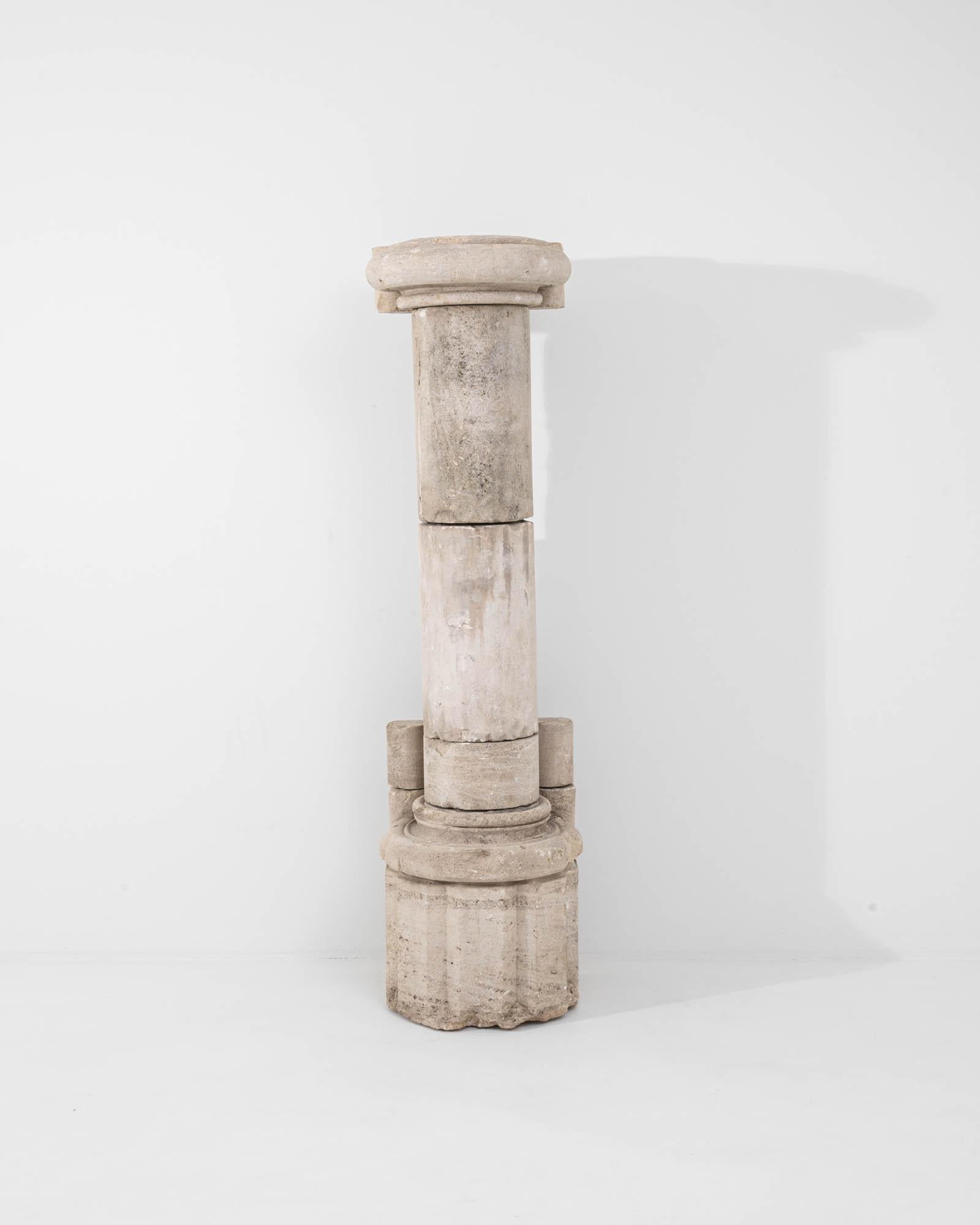 A relic from another time, this antique stone column evokes a sense of romantic ruin. Built in France circa 1800, the form is based on the Tuscan columns of classical Roman architecture. The truncated edges of the stone attest to the fact that this