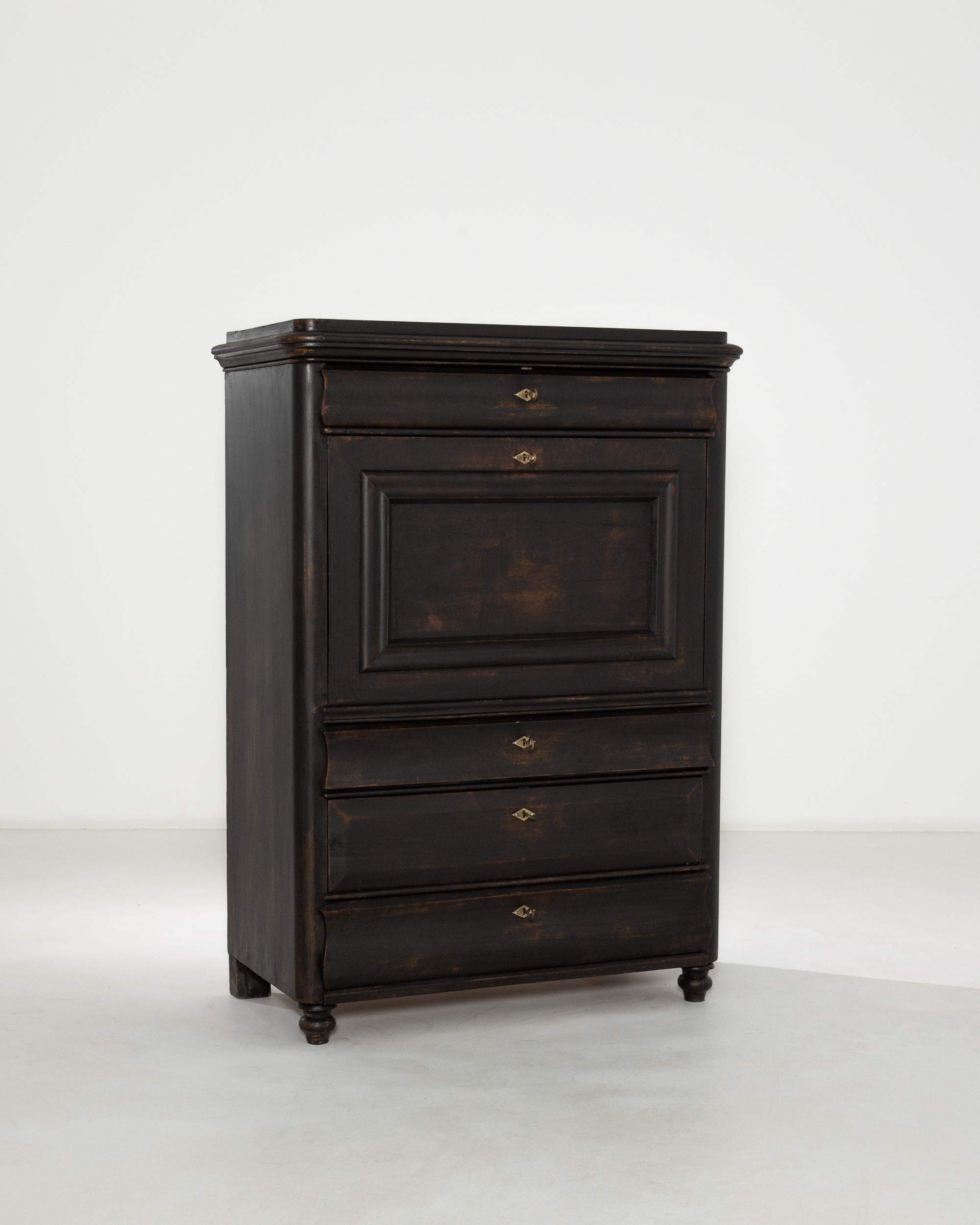 Discover a touch of vintage elegance with this 1800s French Wooden Bar, a relic of bygone opulence with its deep, distressed black patina and elegant craftsmanship. Each drawer and panel is accentuated by classic turn-of-the-century French carvings