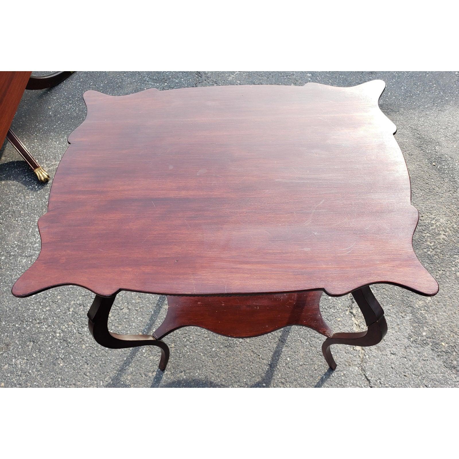 Antique solid mahogany occasional table with waved legs and unique top shape.
We noticed that a leg has been repaired at some point, but apparently not noticeable to our opinion.
  