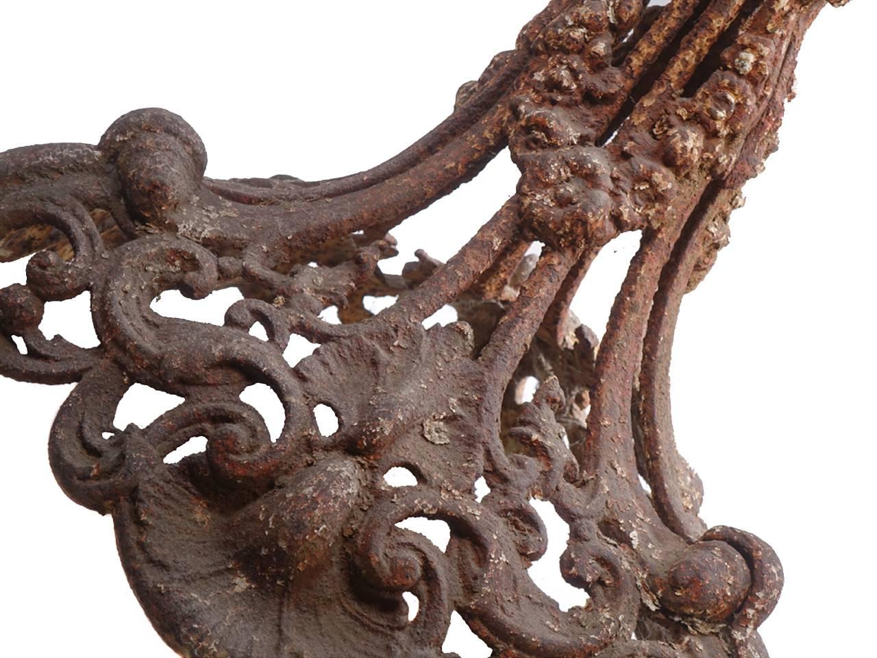 This cast iron base has just the right distressed look. There are small hints of black, and white paint in all the crevices contrasted against an orange rust background. The cast iron is typical Frisk showing all the Victorian ornate detail they