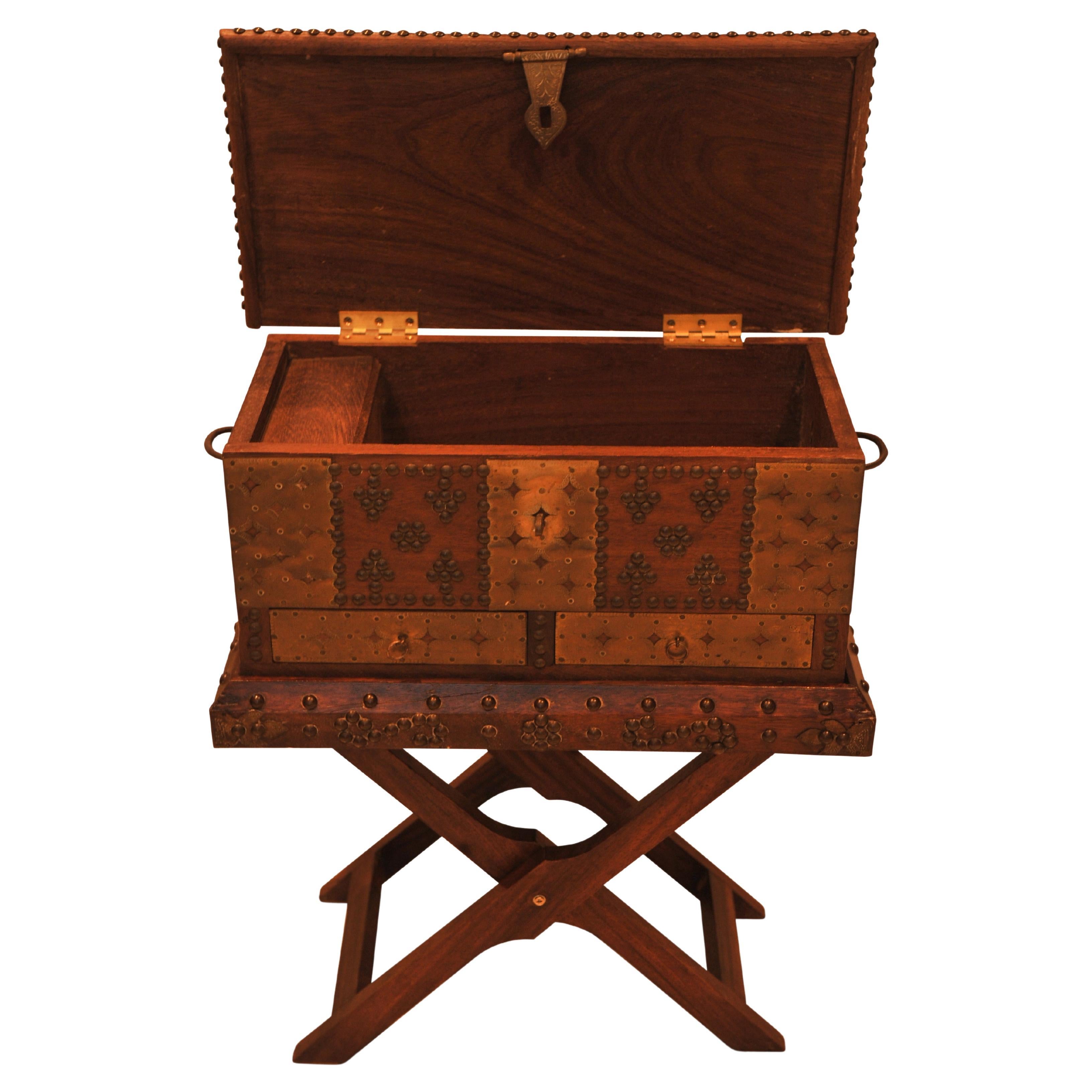 A 19th Century Moorish Zanzibar Brass & Hardwood Decorative Box on Matching Folding Brass Studded Stand

Extra dimensions 
without stand
Height: 21cm
Width: 48.5cm
Depth: 24.5cm 