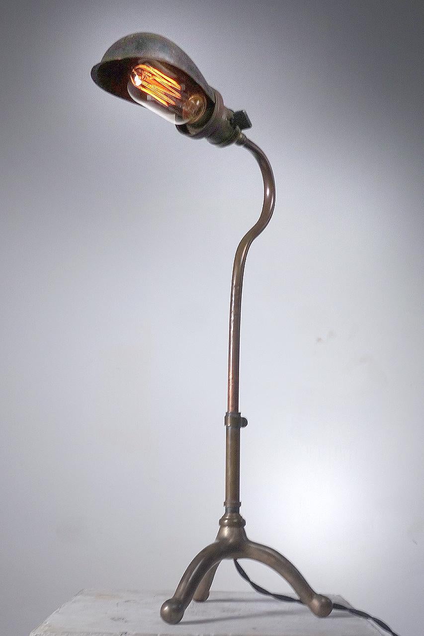 These rare early adjustable industrial desk lamps date to the turn of the century. The lamp is Faries and the shade is an original signed Hubble. They are simple, elegant and have just the right look.