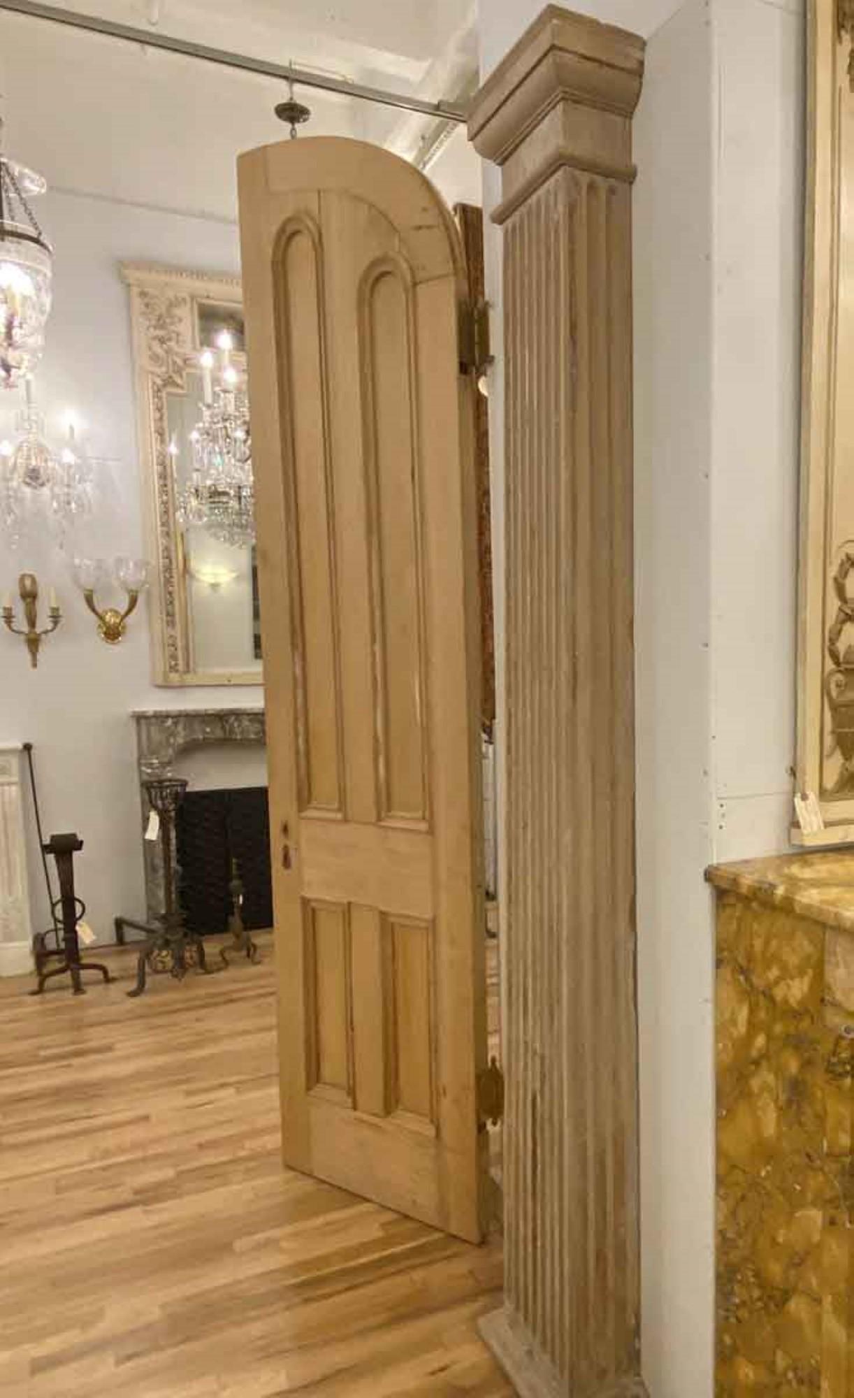 This pair of antique half square fluted pilasters are made of heart pine. Their nice wood grain has been revealed having been almost totally stripped of the paints that once covered it. They have a nice light tone, and a Doric Order capital. These
