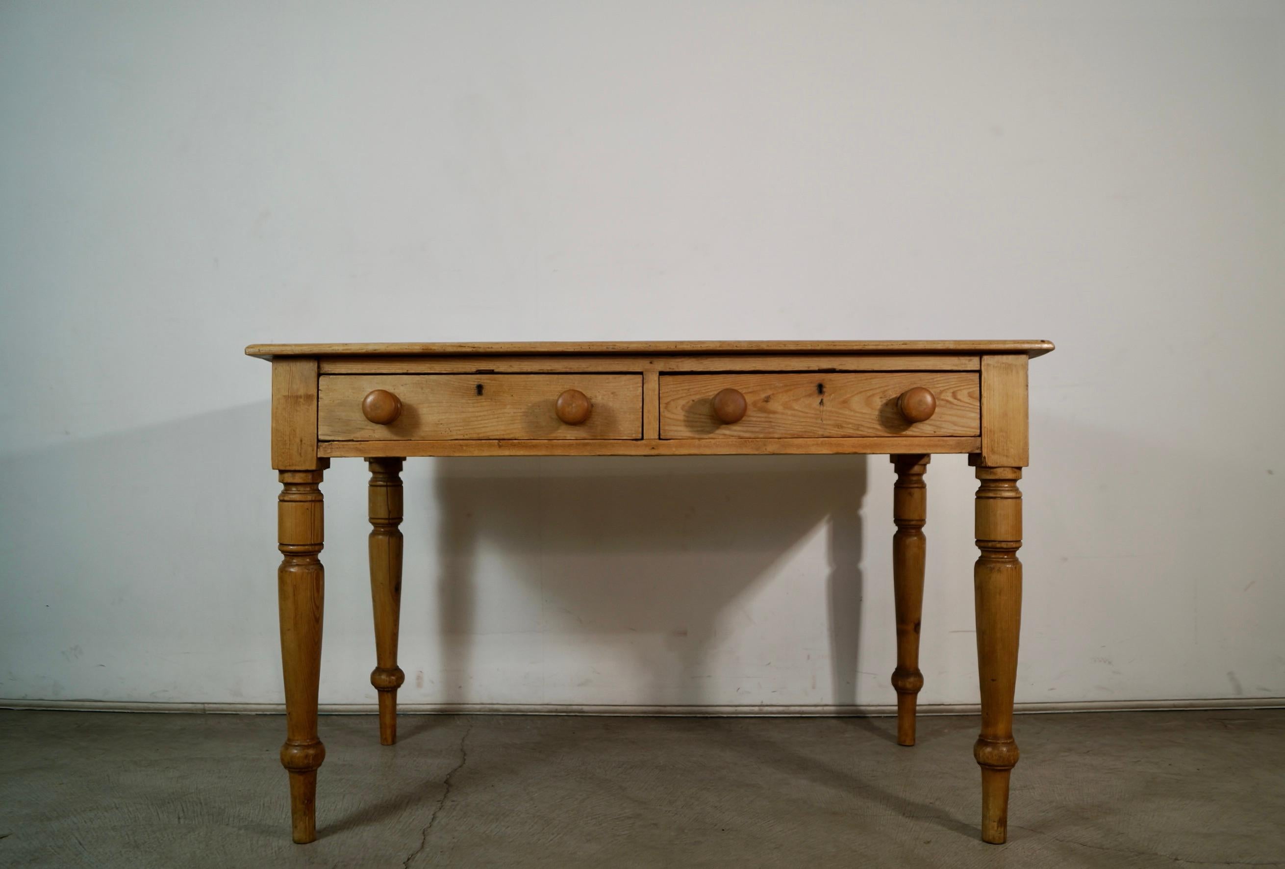 Antique 1800's original farm table for sale. It's made of solid English pine, and has beautiful patina to it. It has two drawers with solid pine knobs on the front, and a backside. It's solid and well made, and can be used as a dining table, farm