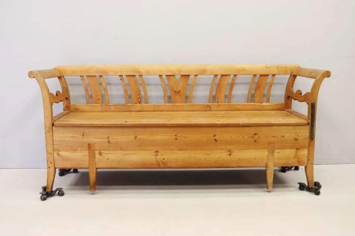 1800s Swedish pine kitchen sofa, classic with graceful, curved lines. Bench seat lifts off to reveal ample storage. In addition, that same bottom drawer pulls out to form an additional sleeping space. Has been repaired at some point within it's 200