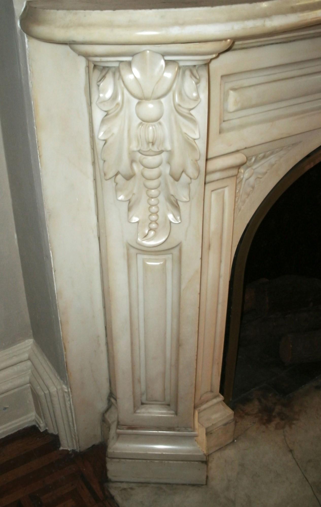 Antique carved statuary marble mantel. Originally the grand mantel of the historic Pen and Brush Club located on East 10th Street, New York City's townhouse estate in 1890. The keystone and corbels are intricately designed and carved. It features