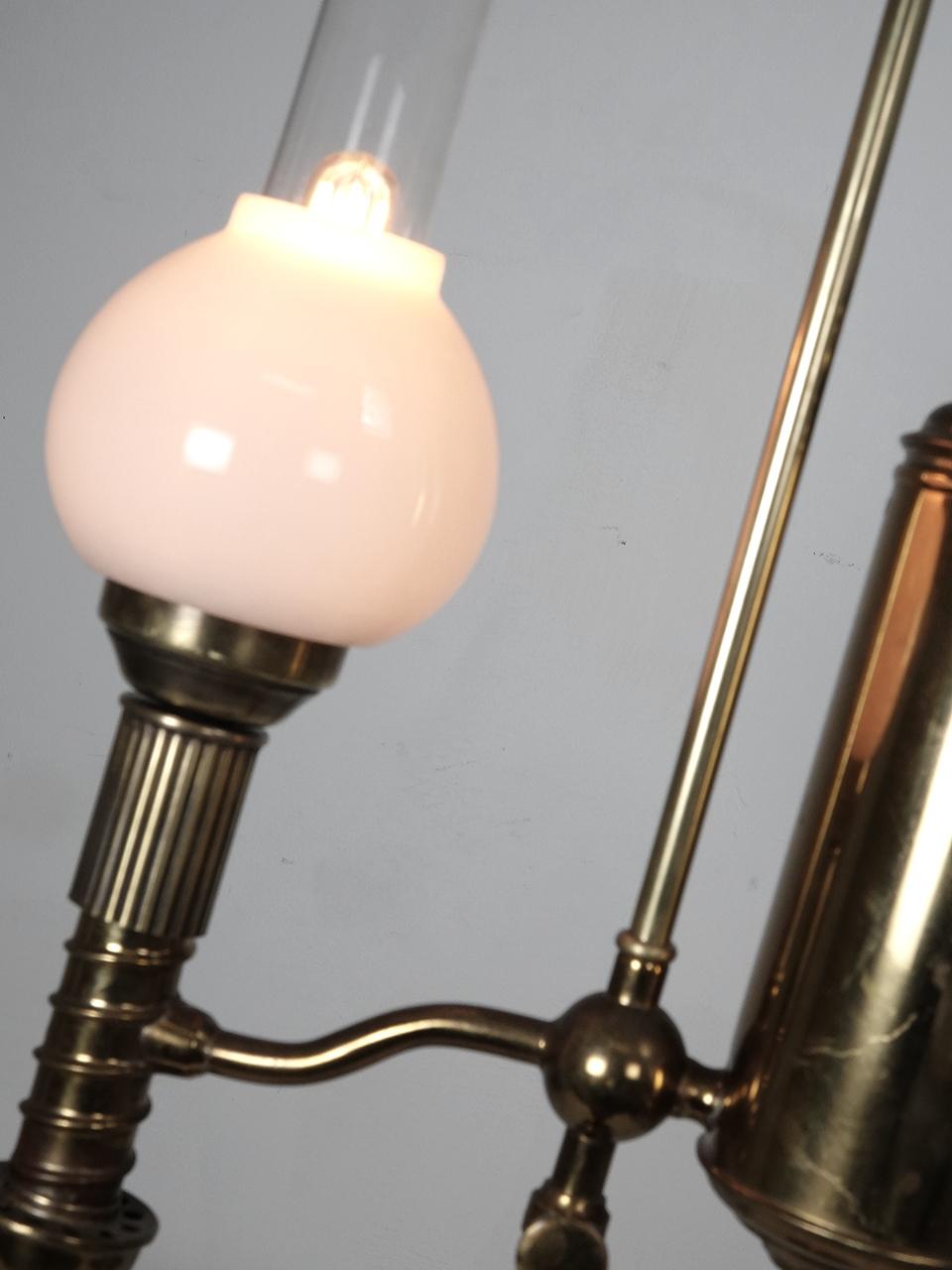 A Victorian period student desk lamp from about 1875 is solid brass, and was meant to burn oil or kerosene. The tank is off to the side, helping light shine down onto a desktop. This lamp is now electrified and takes standard bulb.
  