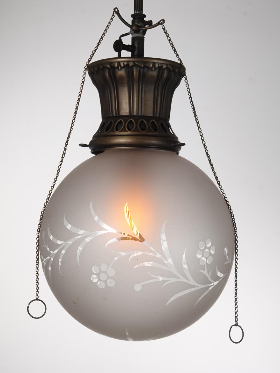 This is a nice, simple and elegant early gas pendent. It has been wired to now take a standard E12 bulb retaining the original look. The 8 inch frosted globe is hand cut to clear with a floral design. The crown is signed and still features the