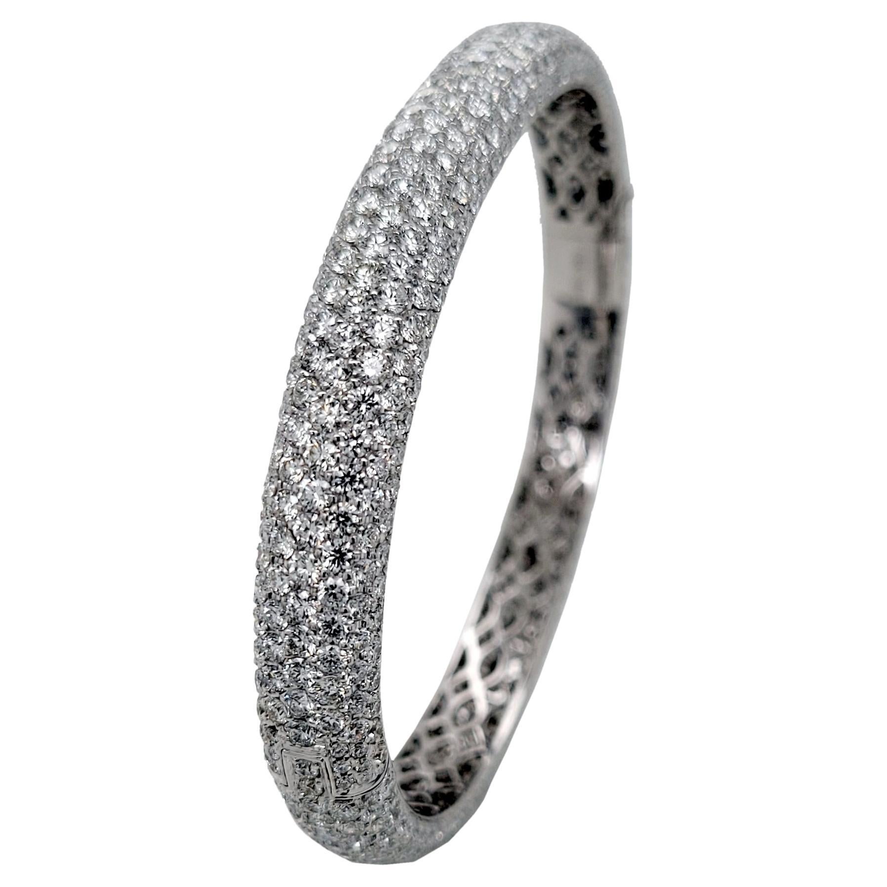 This elegant Oval Shaped Pave Set Diamond Bangle Bracelet is made in 18K White Gold and it is 2.75x2.25  inch in dimension and 8.1 mm wide. This bracelet is made by the highest quality craftsmanship as it can be seen in pictures detailing the piece.