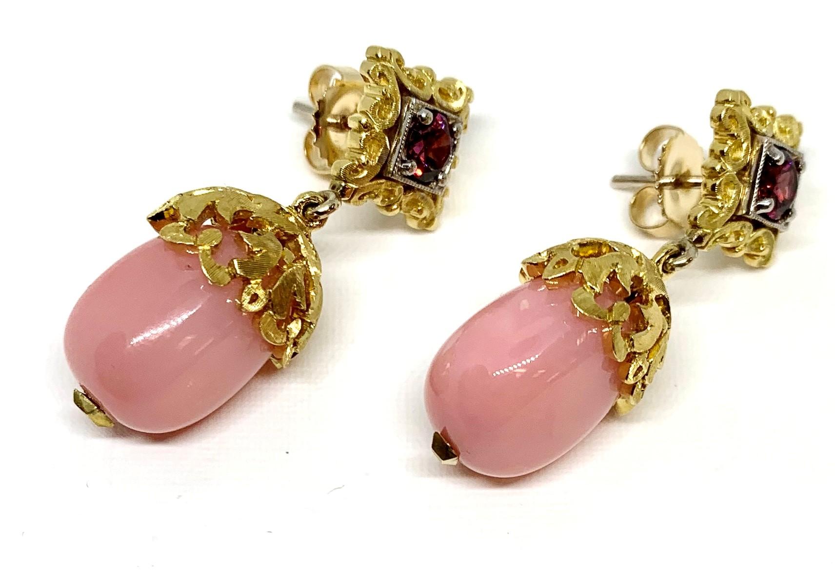 These beautifully handcrafted Peruvian opal and garnet drop earrings are sure to demand compliments whenever you wear them! Two strawberry-shake pink colored opals  (18.08 carats total weight) pair beautifully  with two raspberry color rhodolite