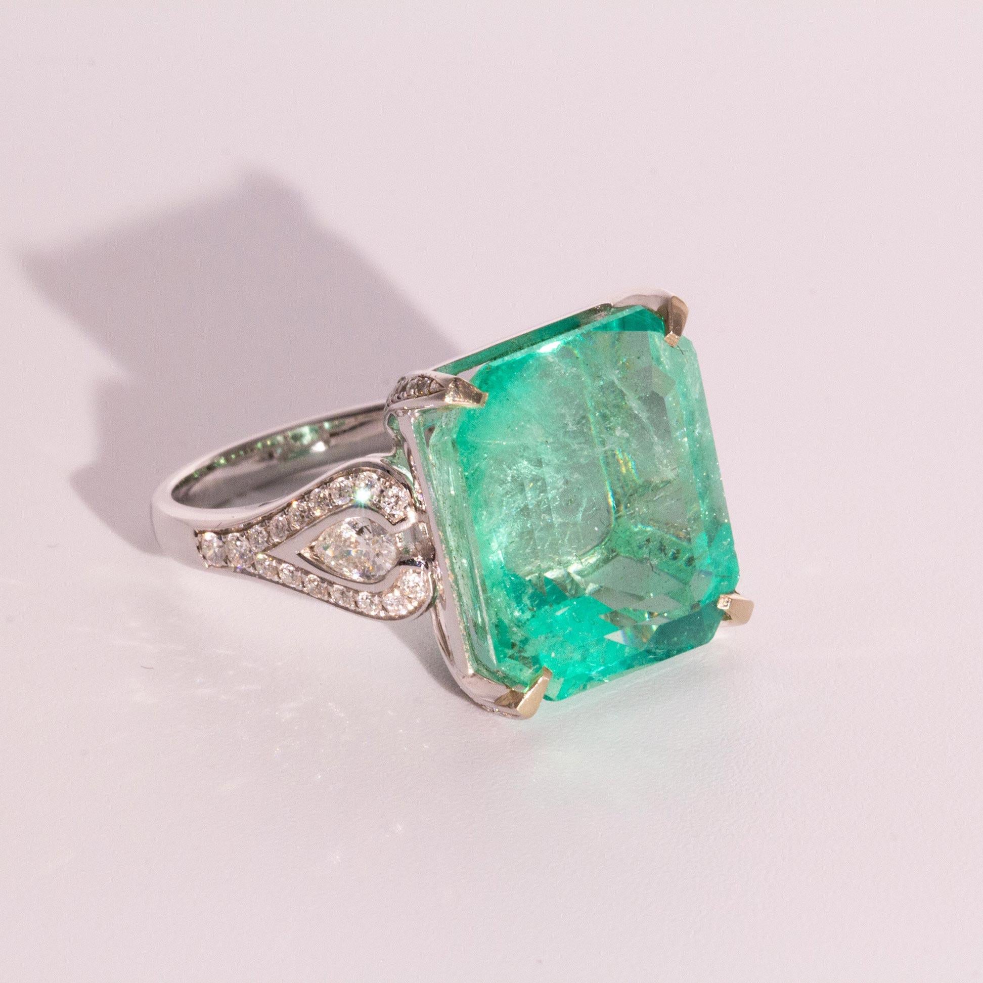 This 18.09 Carat Emerald and Diamond 18 Carat White Gold Ring is certainly a showstopper! Imagine yourself wearing this breathtaking emerald ring to the amazement of others. 

Featuring an emerald of 'moderate' treatment flanked by pear cut diamonds